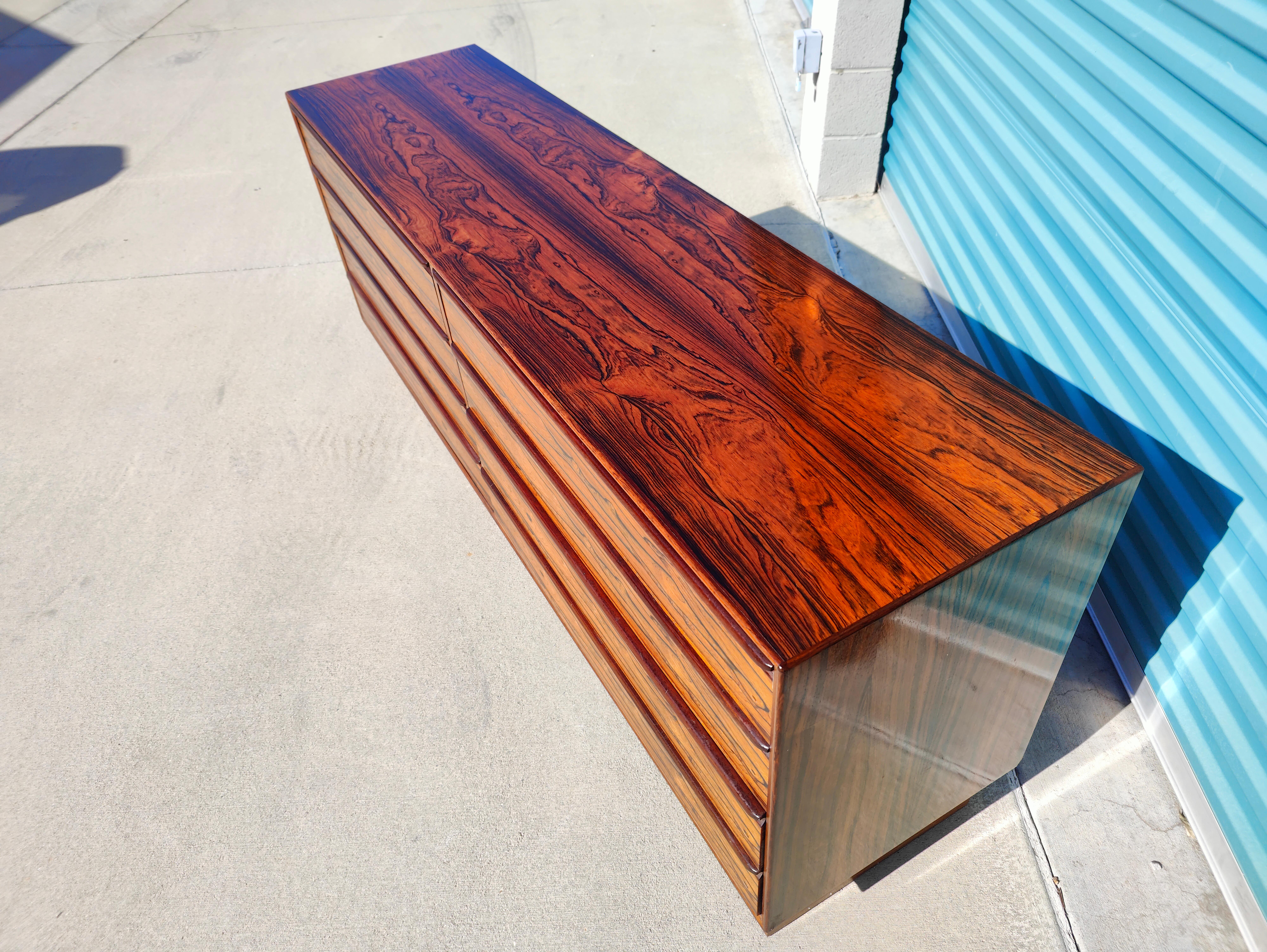 Now available is an amazing Westnofa 8 drawer dresser in a beautiful rosewood finish. Sits on a plinth base. Features amazing bookmatched grain. Measures: 71.5 W x 18.25 D x 29 T.

    