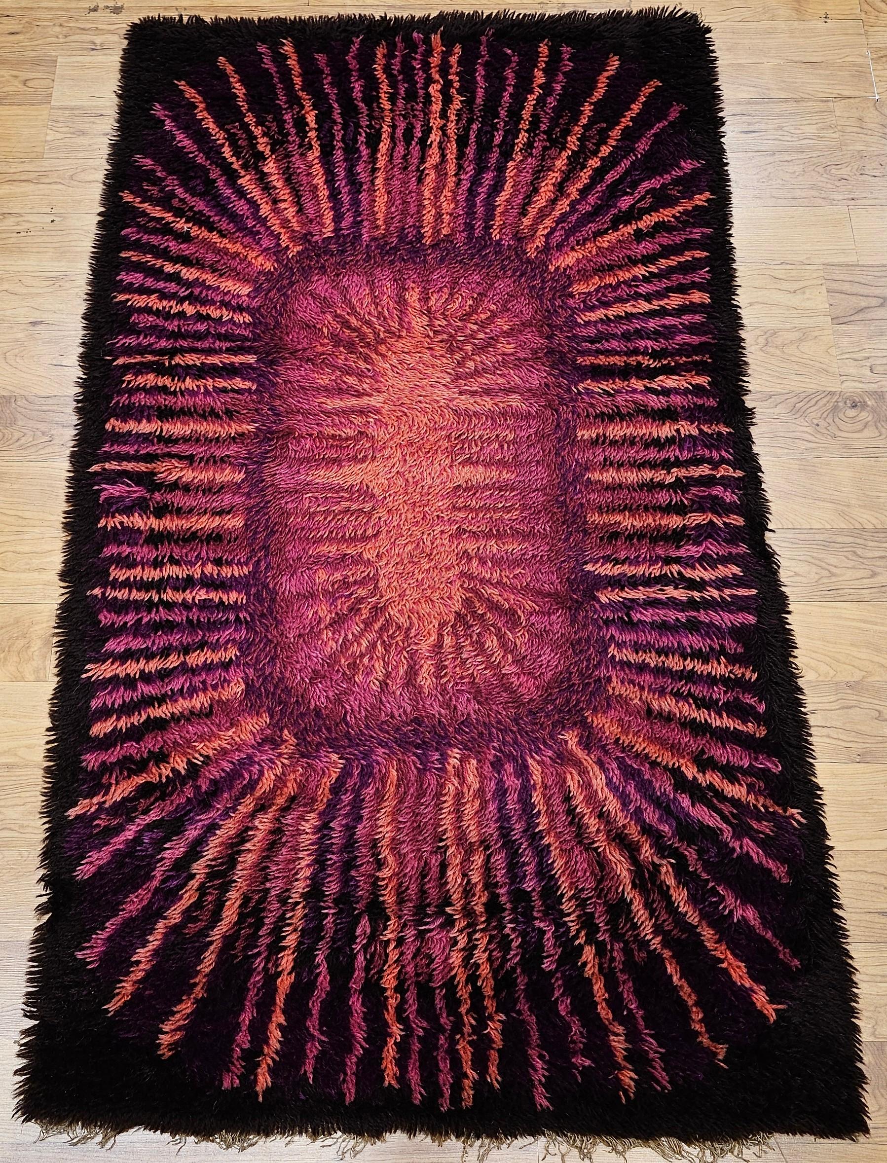 Wonderful and colorful mid century modern Rya area rug in crimson, red, lavender,  pink, and brown colors.

Dimensions:  36” x 63”
Date of Manufacture: 3rd Quarter of the 1900s
Place of Origin: Scandinavia
Material: wool
Condition:  Wear consistent