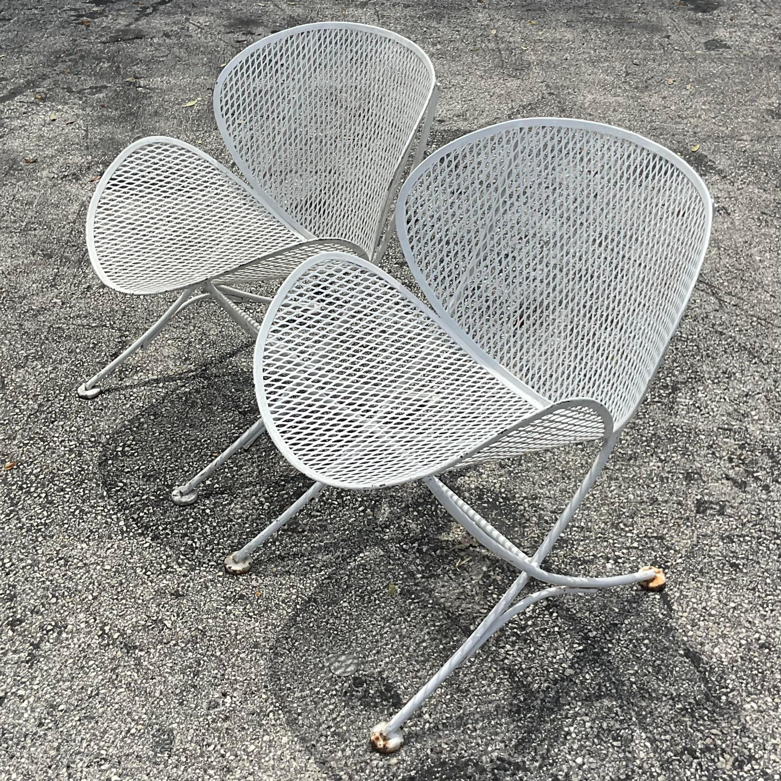 A fabulous pair of vintage MCM lounge chairs. Made by the iconic Salterini group. Unmarked. Thr classic Orange Slice design in a patinated white finish. Acquired from a Palm Beach estate.

Seat height 13.5