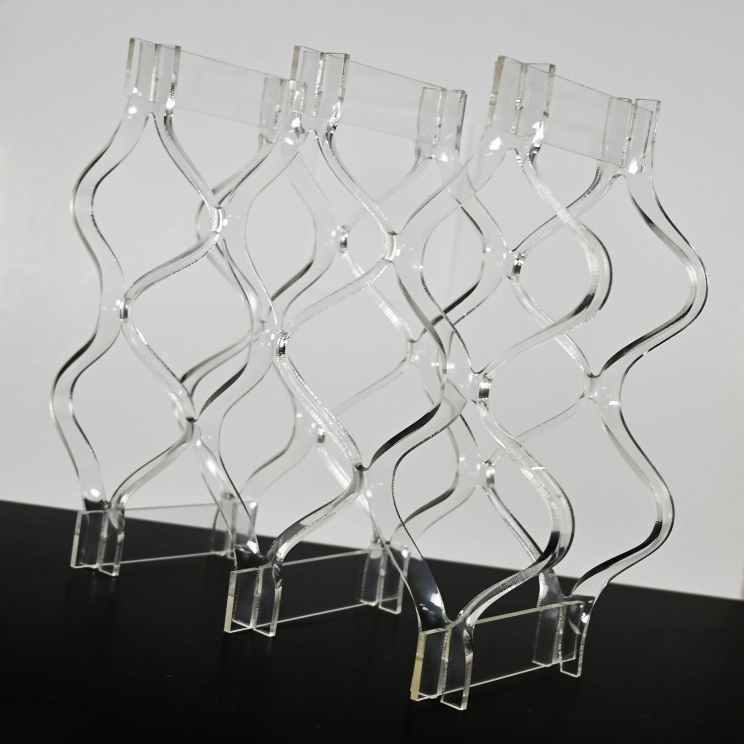 Lovely vintage Mid-Century Modern sculpted Lucite or plexiglass wine rack. Beautiful condition, keeping in mind that this is vintage and not new so will have signs of use and wear. Please see photos and zoom in for details. We attempt to portray any