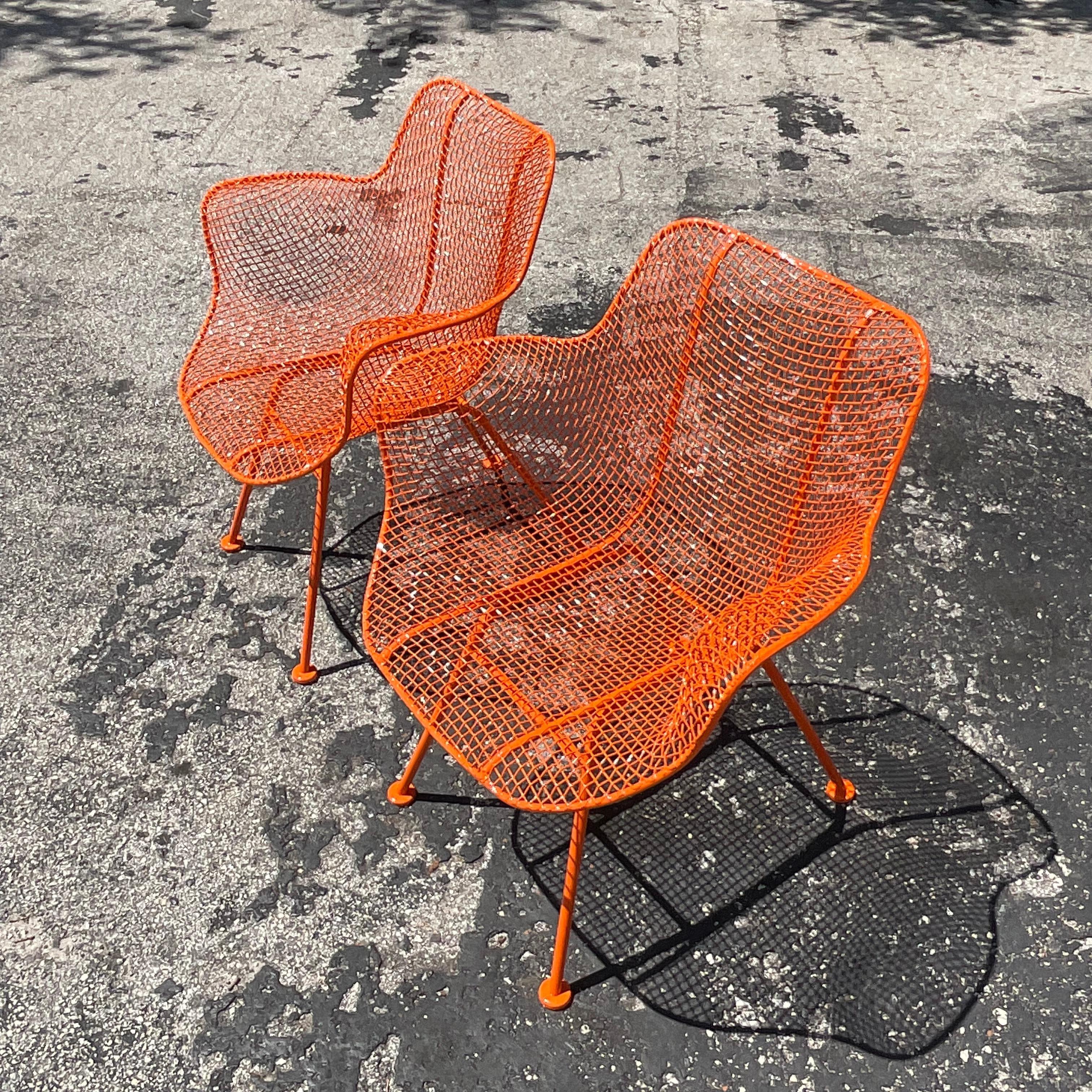 Capture the essence of mid-century modern Americana with this pair of Vintage MCM Russell Woodard 'Sculptura' Wrought Iron Chairs. Iconic in their design, these chairs showcase the epitome of American craftsmanship and style. Crafted by Russell