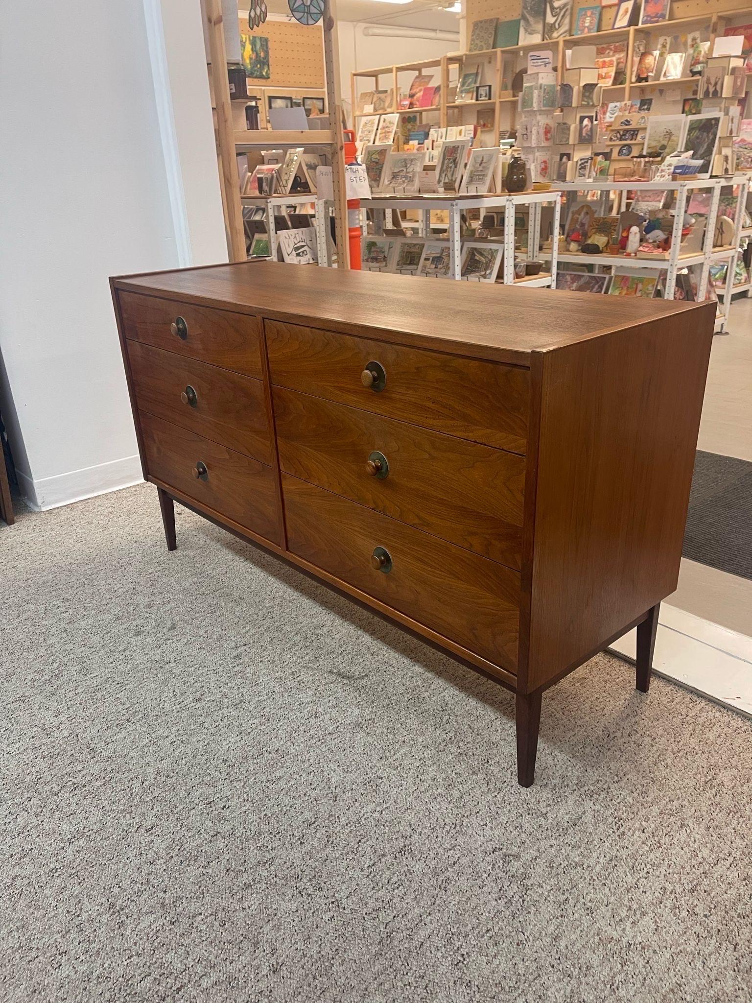 This Dresser Features Six Dovetailed Drawers with Original Turned Wood Handles. Tapered Legs, Walnut Toned Wood. Vintage Condition Consistent with Age as Pictured.

Dimensions. 52 W ; 18 D ; 30 H