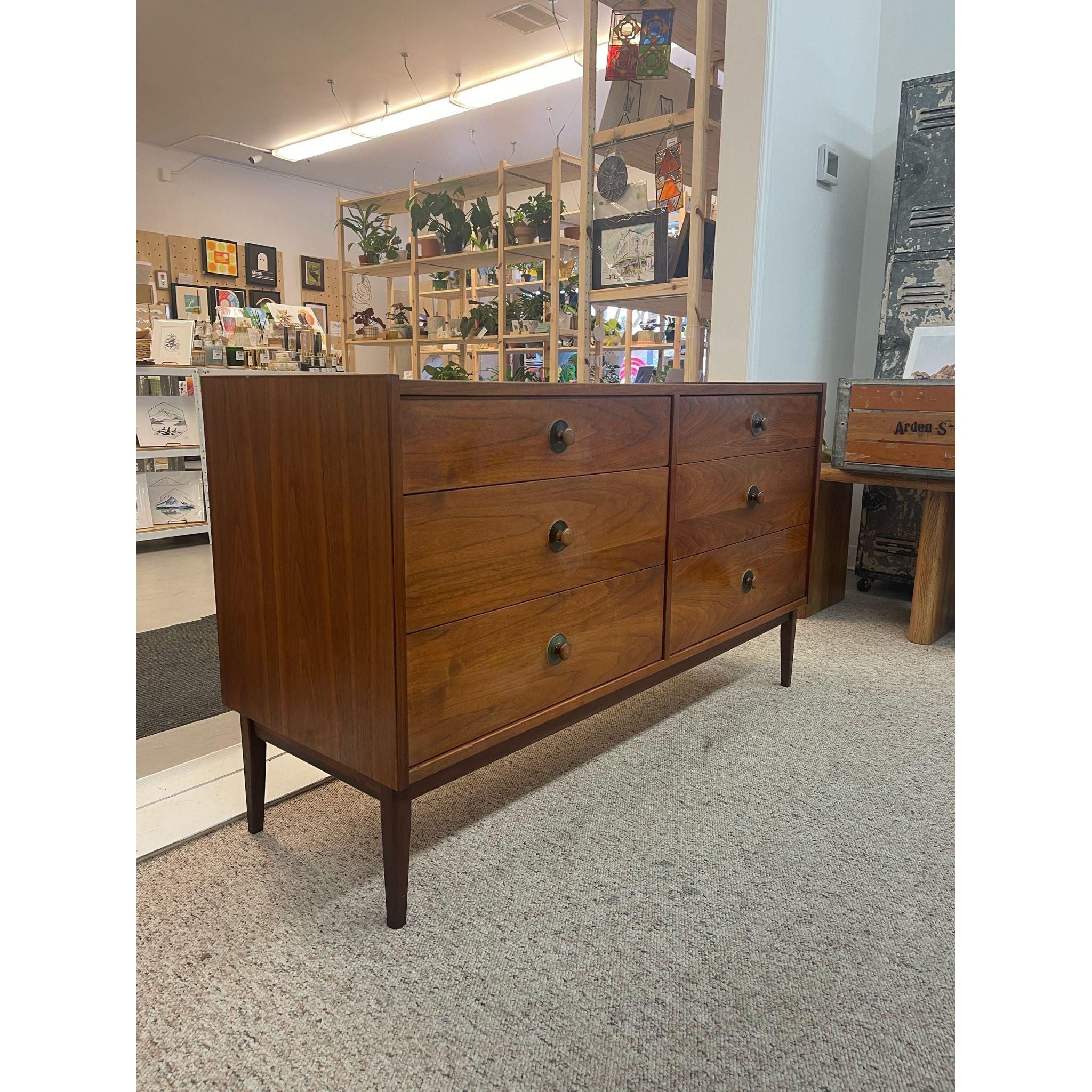 This Dresser Features Six Dovetailed Drawers with Original Turned Wood Handles. Tapered Legs, Walnut Toned Wood. Vintage Condition Consistent with Age as Pictured.

Dimensions. 52 W ; 18 D ; 30 H
