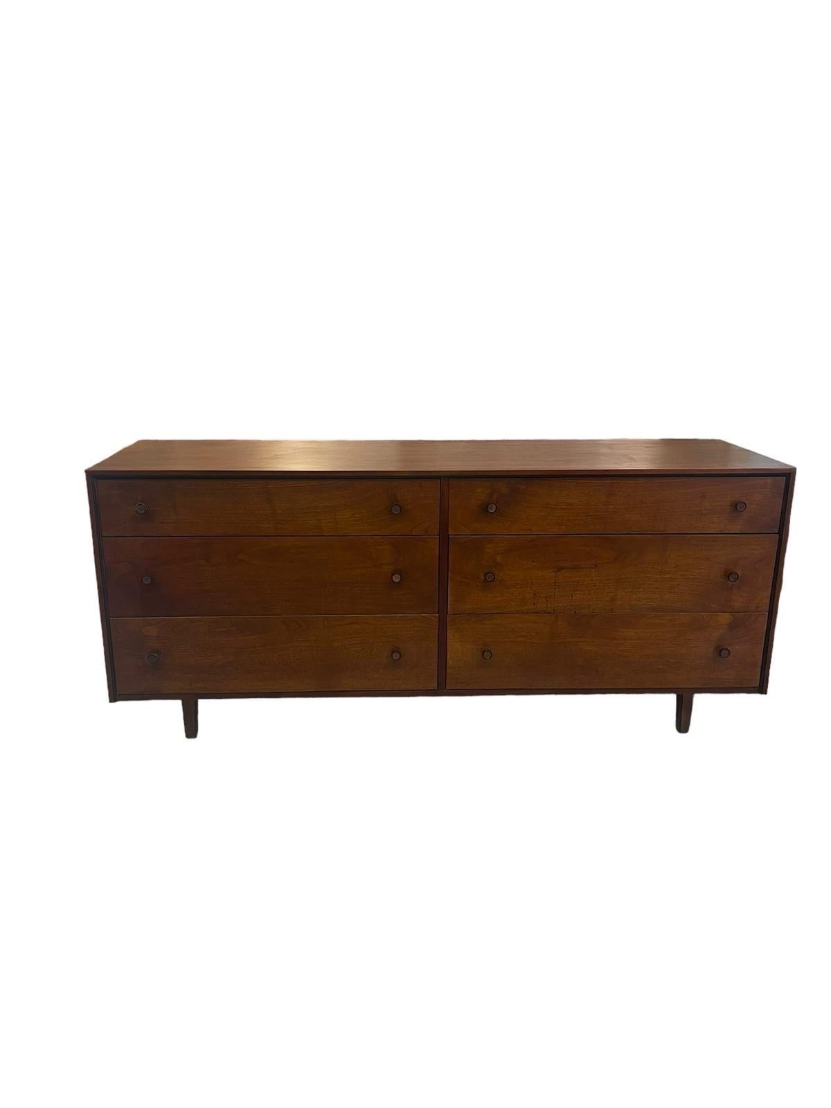 This Dresser features original wood and metal hardware. Dovetailed Drawers. The frame,handles and legs are accented with black line detailing as shown. Vintage Condition Consistent with Age as Pictured.

Dimensions. 65 W ; 18 1/2 D ; 28 H