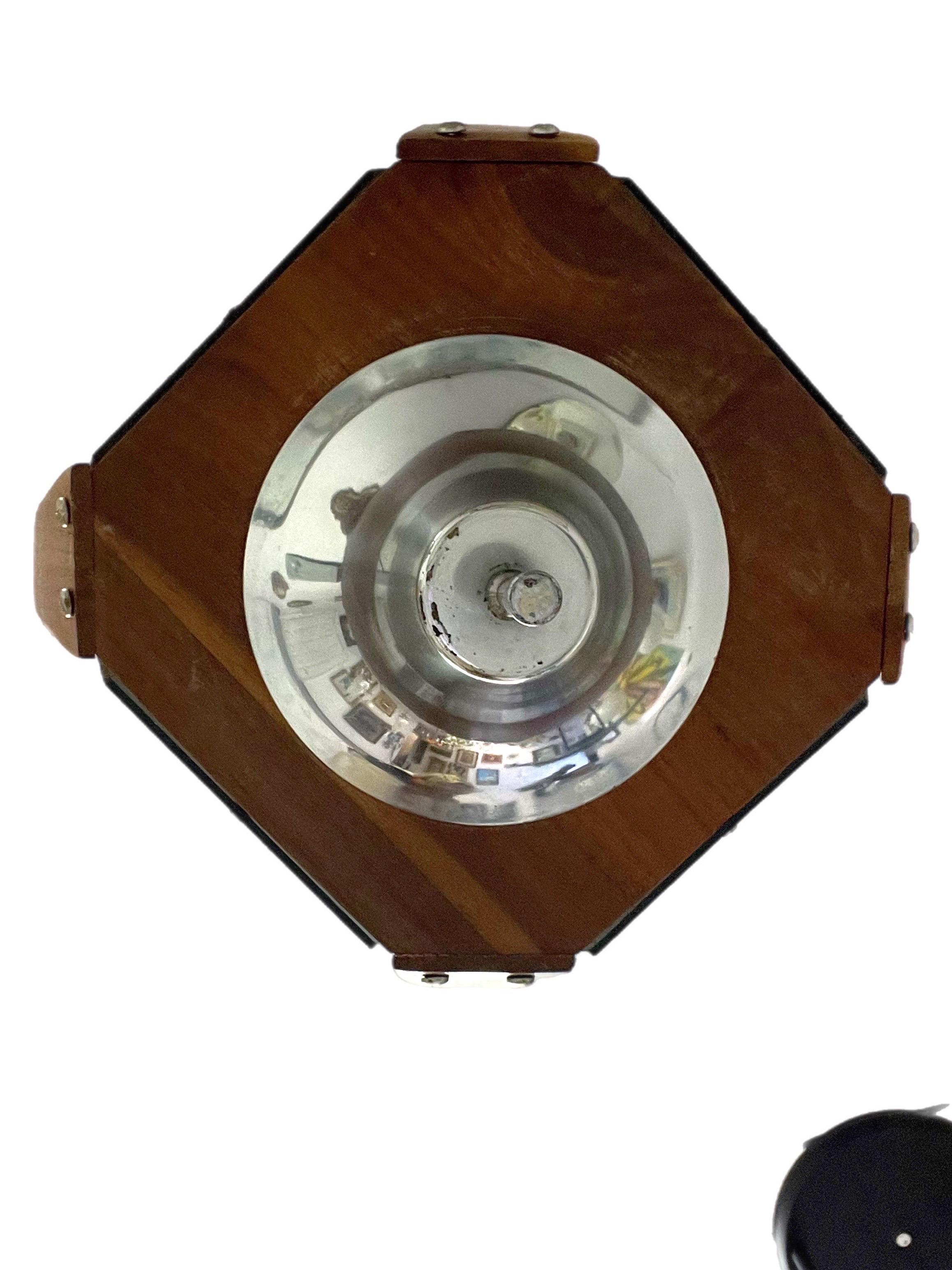 This cool overhead lamp features smoked acrylic panels surrounding a chrome frame with bent wood walnut corners which hangs from a corded chain.  The interior features 4 candle form interior lights.  The measurements are from the finial to the