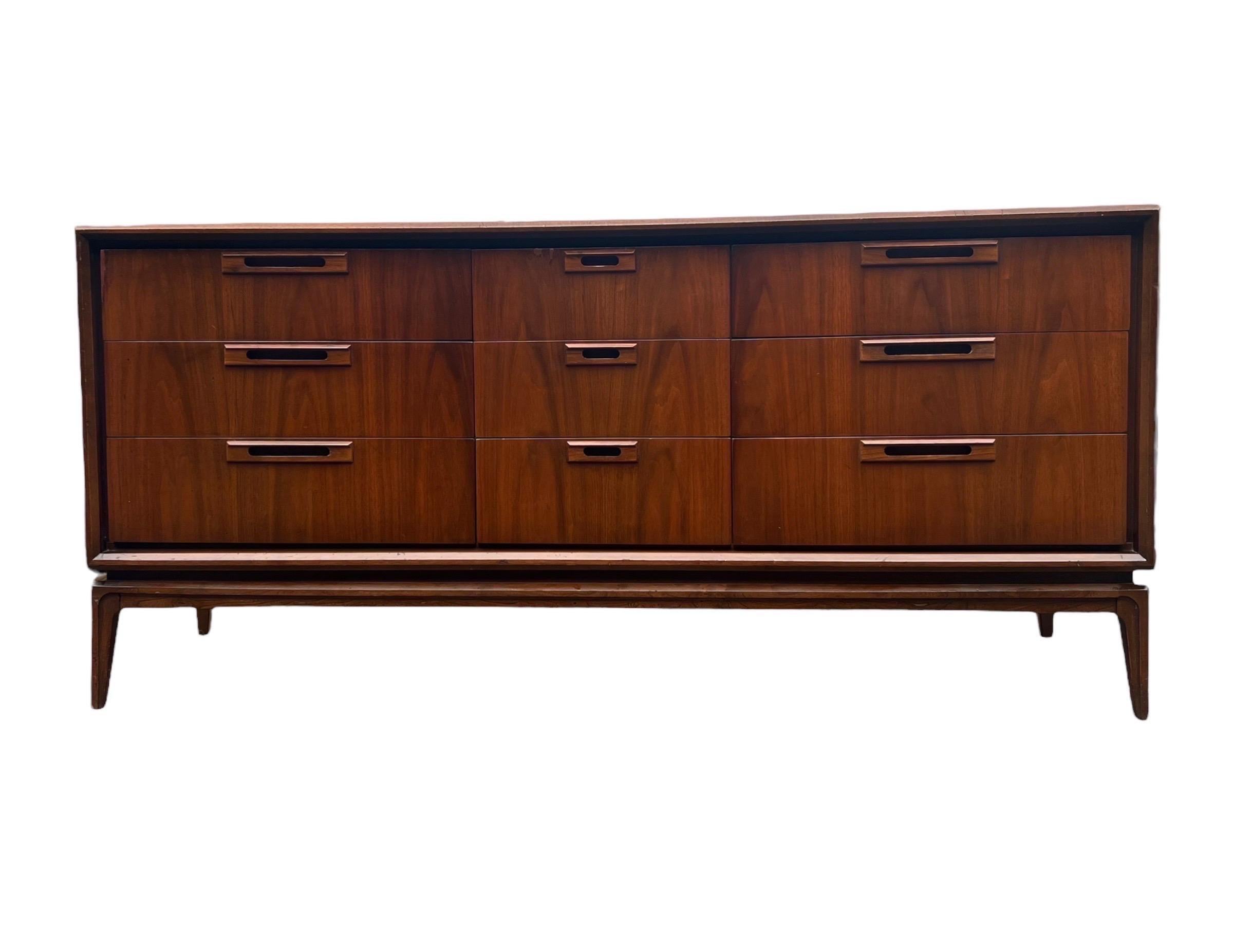 Vintage Mid Century Modern Solid Walnut 9 Drawer Dresser Recessed Pulls by Stanley

Dimensions. 66 W ; 19 D ; 31 H