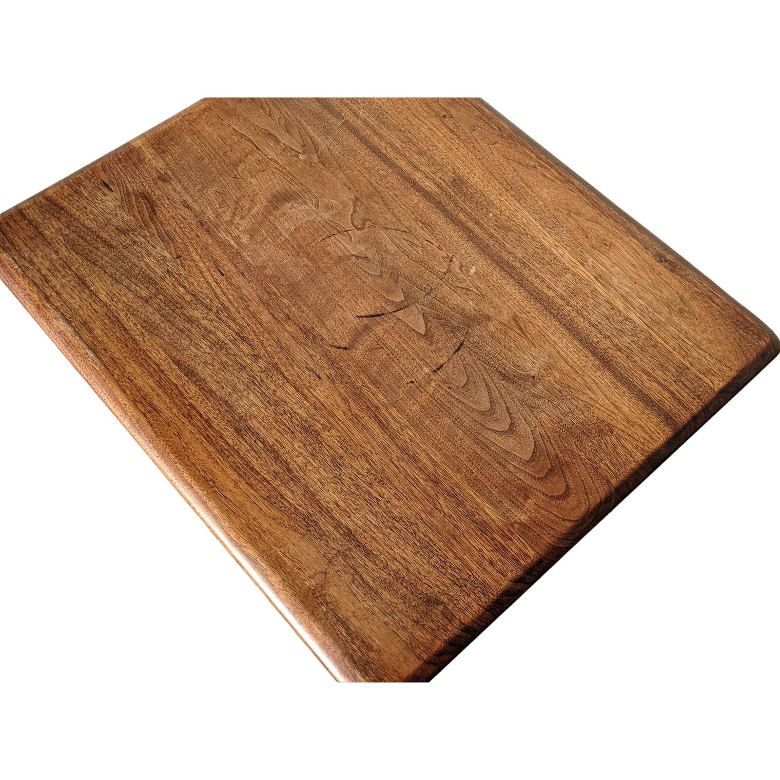 An elegant Vintage Mid-Century Modern side table, crafted from solid walnut, featuring a square top supported by a distinctive pedestal base.

This piece embodies clean lines and a minimalist aesthetic with the warmth of natural wood. The table is