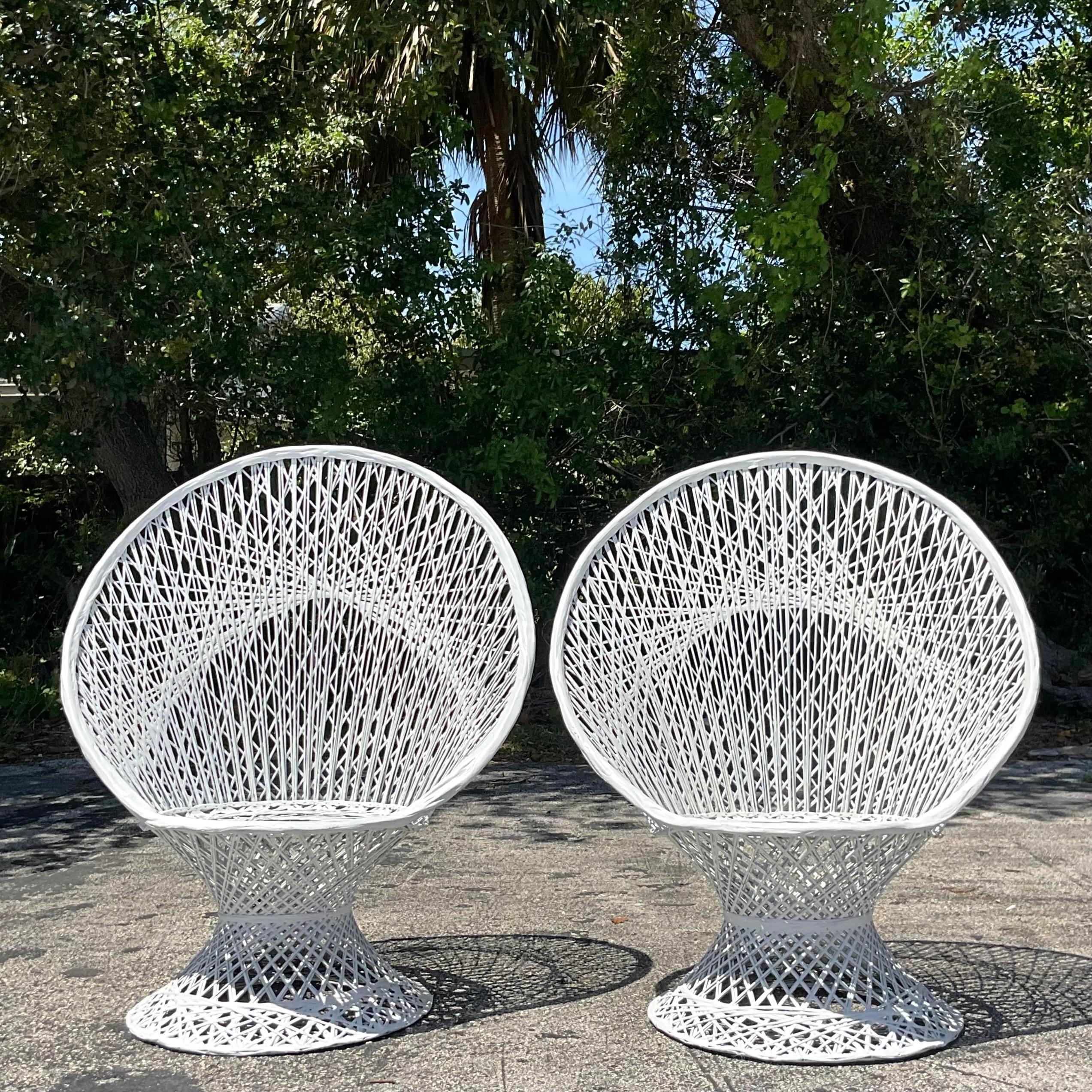Experience mid-century modern flair with our Vintage MCM Spun Fiberglass Peacock Chairs - Pair of 2. These iconic chairs boast a striking peacock design crafted from spun fiberglass, blending retro charm with American design sensibility for a