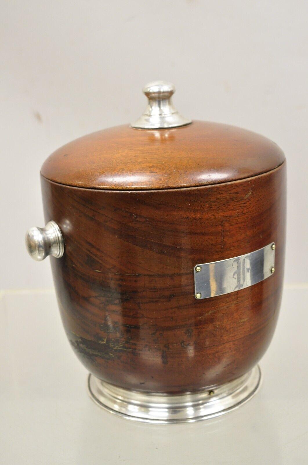 Vintage Mid-Century Modern sterling silver and turned carved mahogany ice bucket. Item features a sterling silver plaque to front with 