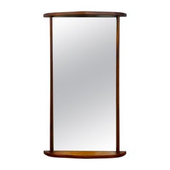 Espejo de pared vintage de estilo «Mid-Century Modern» con marco de madera curvado.