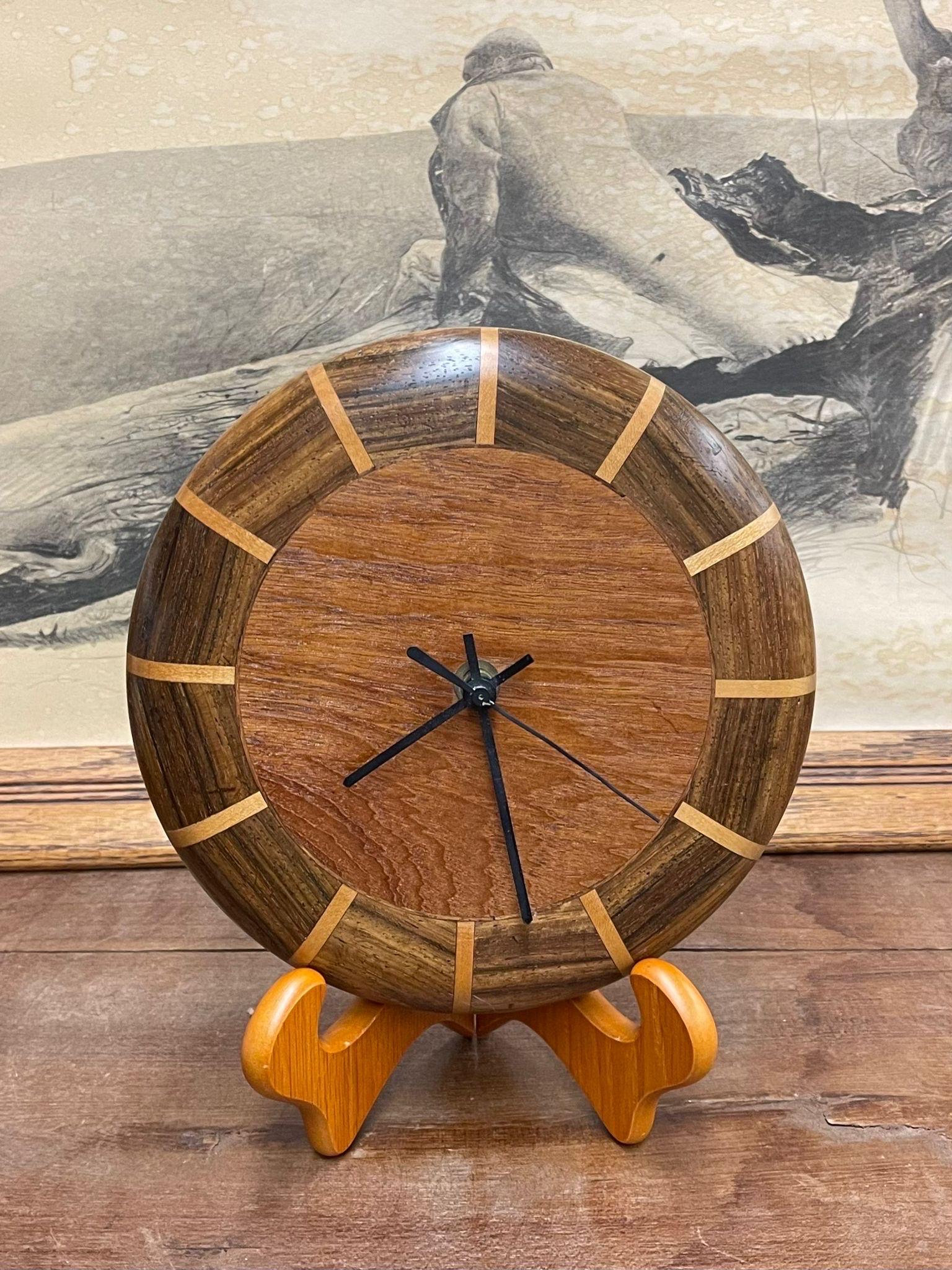 Sleek Wooden Wall Clock with Different Wood Textures. Stand Not Included. Operational Ability Unknown . Vintage Condition Consistent with Age as Pictured.

Dimensions. 9 1/2 Diameter; 2 D