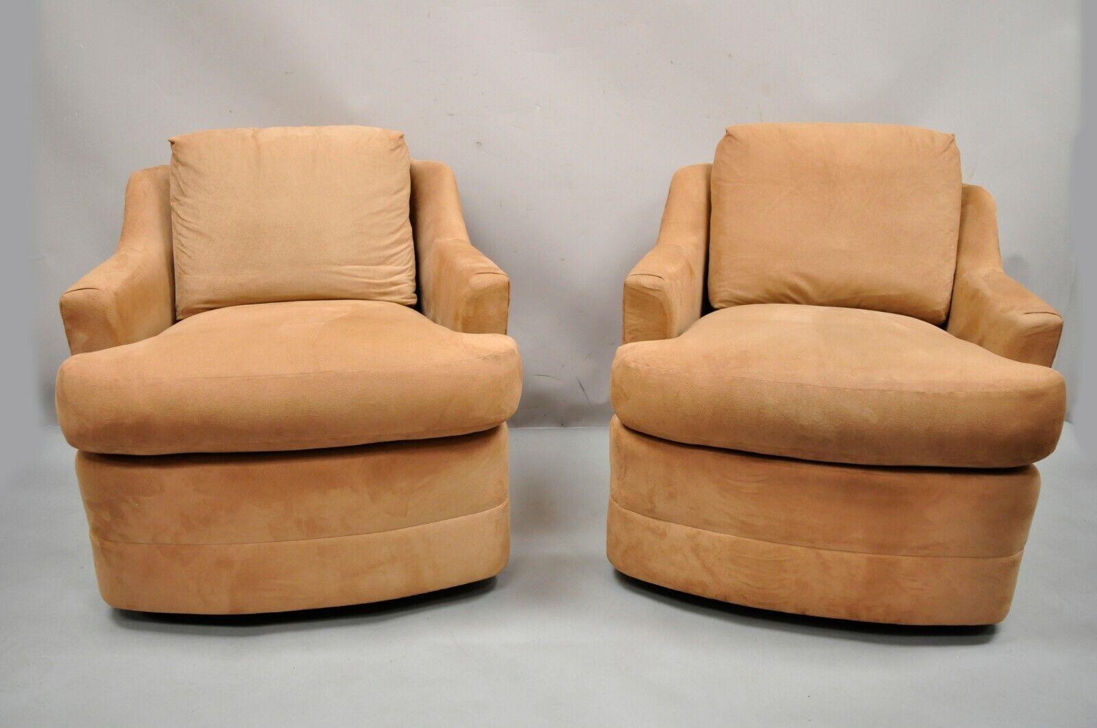 Vintage Mid-Century Modern swivel brown upholstered lounge club chairs - a pair. Item features a round swivel pedestal base, fully upholstered frames, Ultrasuede fabric, very nice vintage pair, clean modernist lines, quality American craftsmanship.