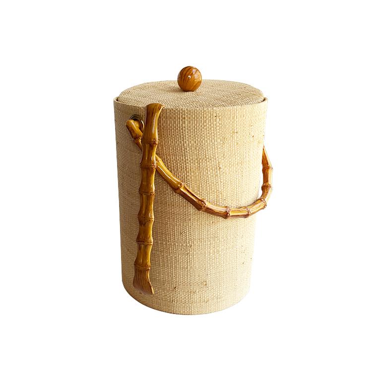 A lovely MCM grasscloth covered ice bucket with lid and bamboo handle and matching tongs. Covered in a cream grasscloth, this tall bucket is insulated on the inside and perfect for a bar. The round lid has a wood ball handle and a lacquered bamboo