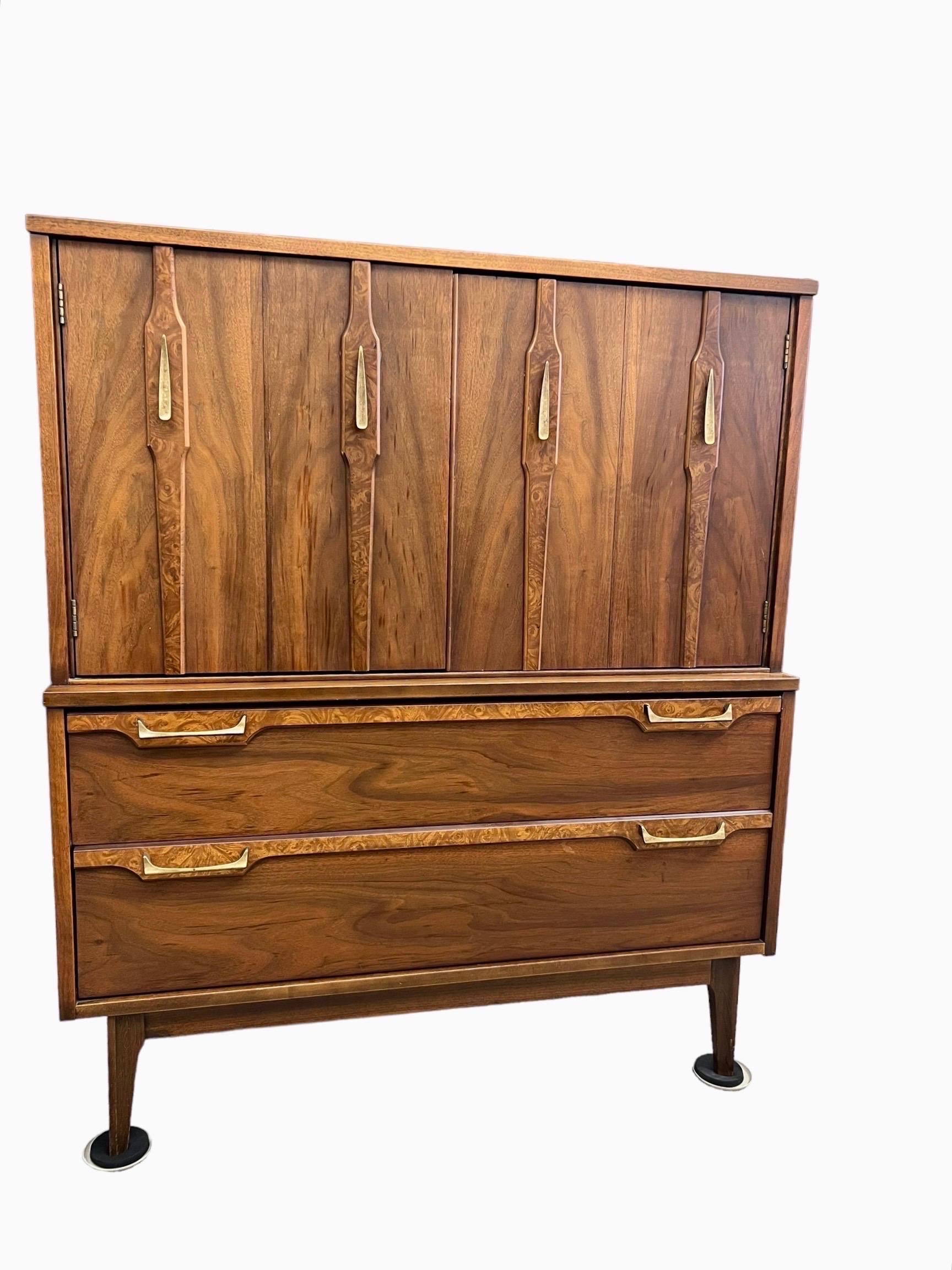 This Sophisticated, Tall Gentleman’s Chest is Finished in Walnut With Burl Accent. The Door and Dovetailed Drawers Features Sculptural Solid Brass Pulls. There are Three Additional Drawers Behind the Upper Doors.

Dimensions. 40 W ; 18 D ; 47 H