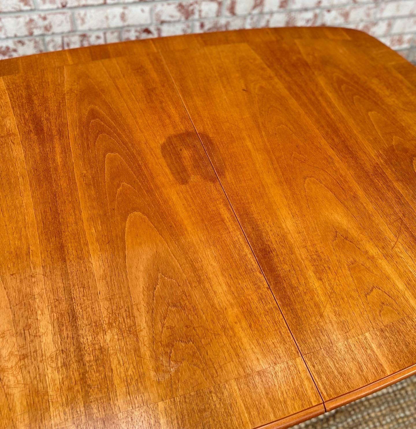 Gorgeous unique mid century dining table by McIntosh. Leaf pops up from under the table, and it’s very convenient. Some discoloration and marks on the top. Legs in good sturdy condition!
  