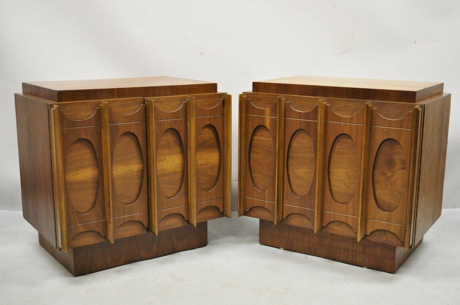 Vintage Mid-Century Modern Tobago sculpted walnut nightstands - a pair. Item features beautiful wood grain, nicely craved details, 2 swing doors, 1 wooden shelf, very nice vintage pair, clean modernist lines, great style and form. Mid-20th century.