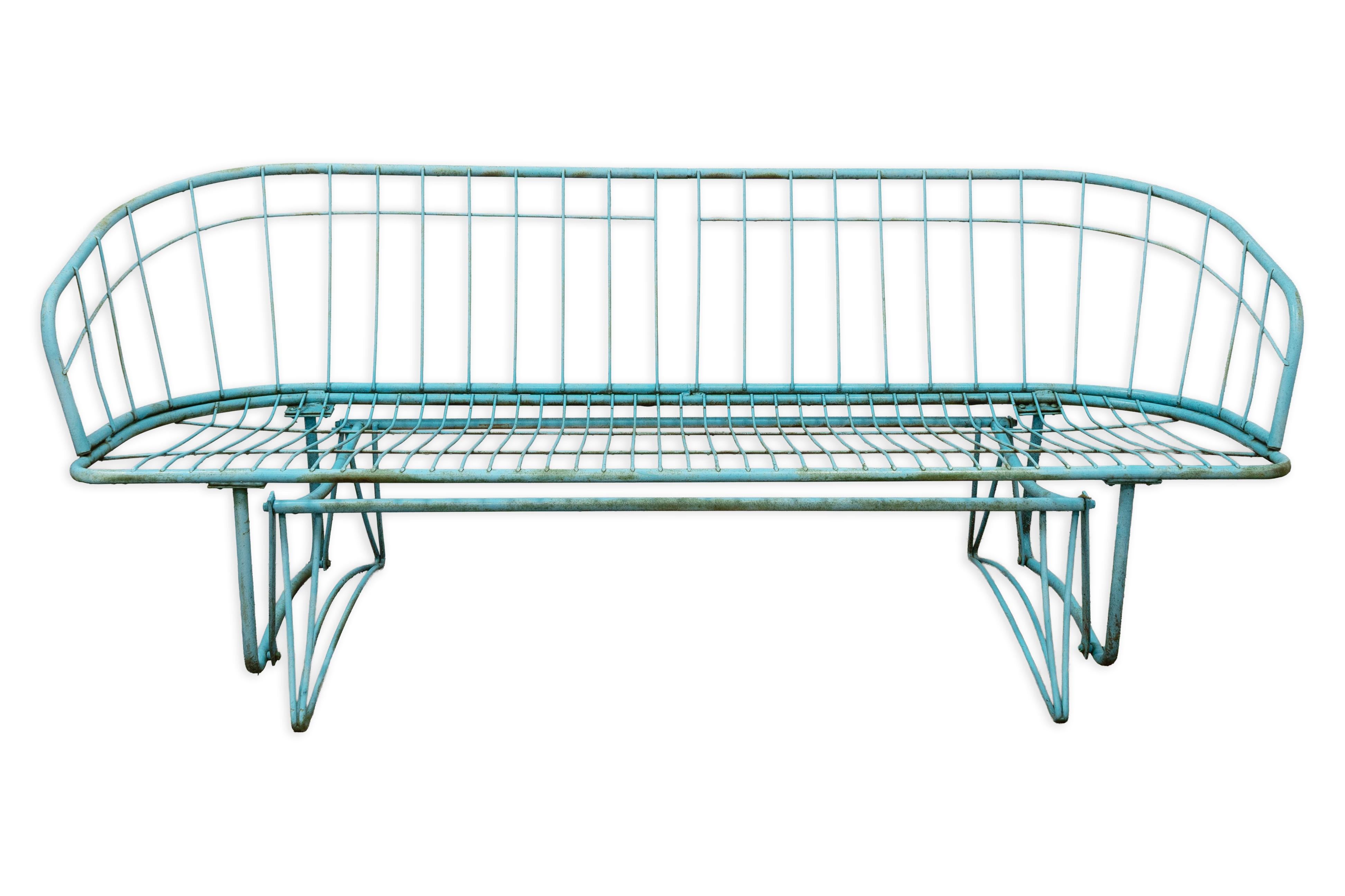A charming example of mid-century outdoor design, this vintage Homecrest 3-seater glider bench features the iconic atomic-era silhouette the brand is known for. Crafted from durable wrought iron, the bench is finished in its original turquoise