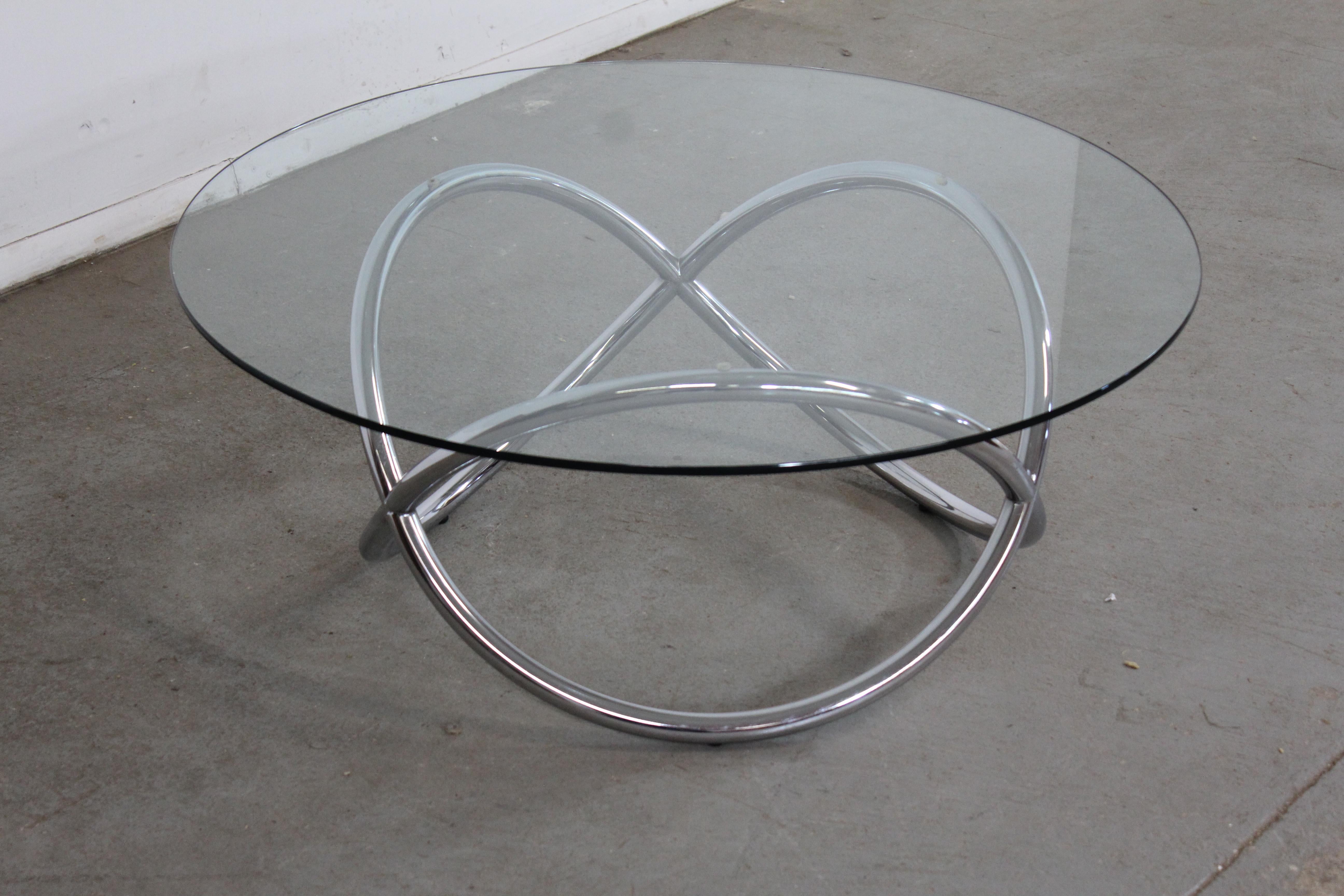 Vintage Mid Century Modern twisted chrome pretzel glass coffee table
Offered is a Vintage Mid Century Modern twisted chrome pretzel glass coffee table. The pretzel lines of the flowing base and design are what make this table stand out. Featuring a