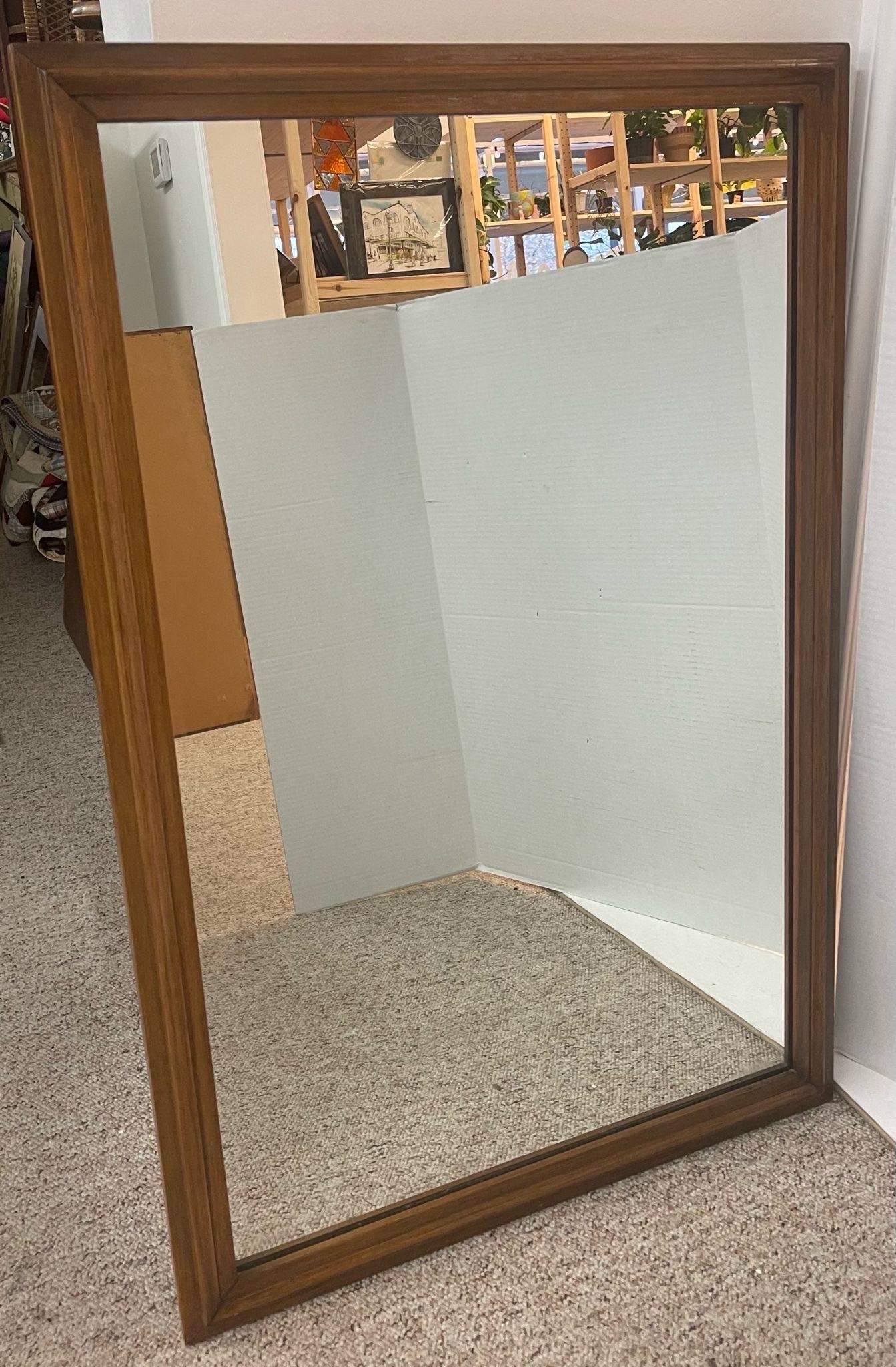 Wood Framed Mirror, No Makers Mark. Beautiful Detailing on the Frame. Vintage Condition Consistent with Age as Pictured.

Dimensions. 27 W ; 1 D ; 41 1/2 H