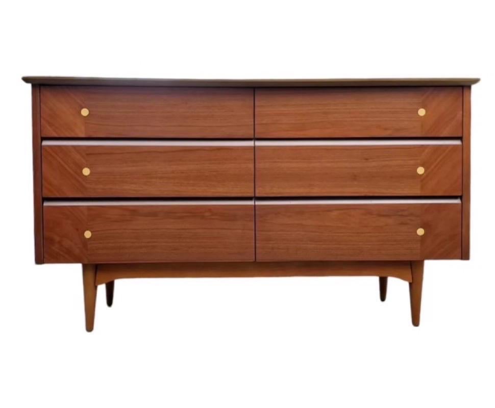 Gorgeous Mid-Century Modern lowboy dresser. Professionally refinished. Excellent and stylish piece in walnut and fruitwood that will look fantastic wherever displayed!

Dimensions. 54 W ;18D; 31H