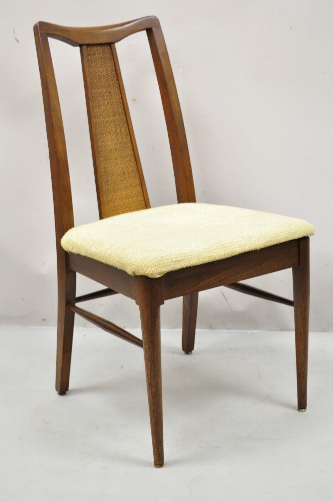 Vintage Mid-Century Modern Walnut Cane Back dining chairs - Set of 4. Item features a cane panel backrest, (4) side chairs, beautiful wood grain, tapered legs. Circa Mid 20th Century. Measurements: 37.5