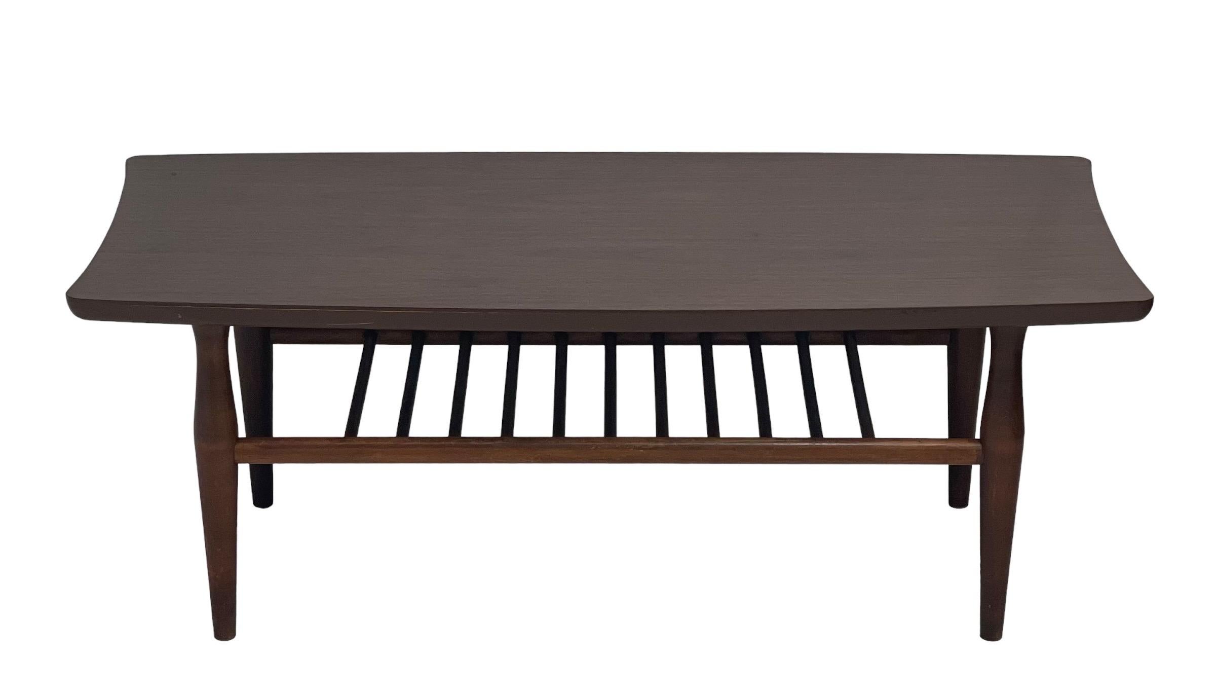 Vintage Mid-Century Modern walnut coffee table With shelf.

Dimensions. 40W 18D 15H.