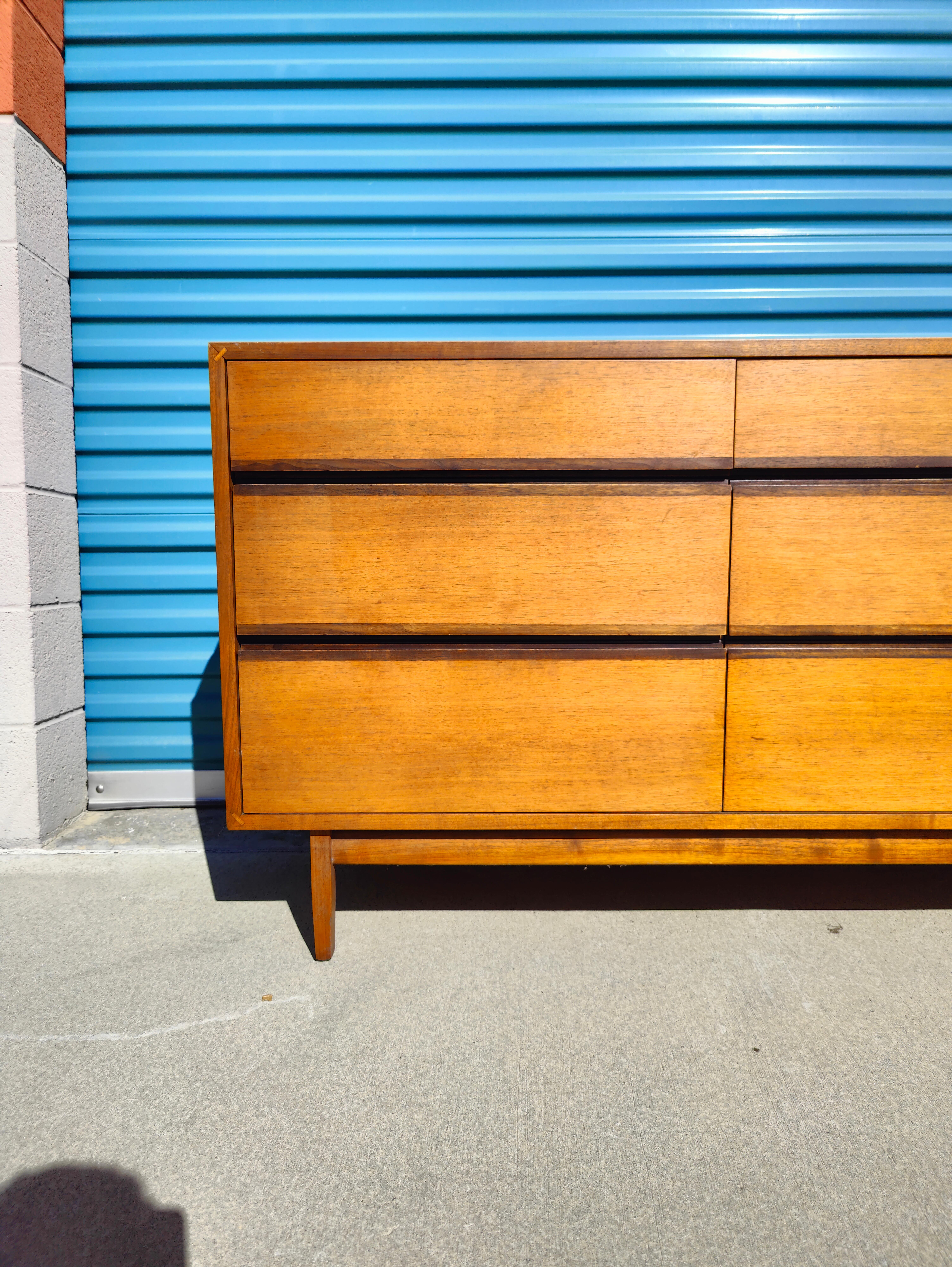 Now available is an amazing dresser/credenza designed by Kipp Stewart for Calvin Furniture c1950s. Features a walnut finish with cane doors. It offers lots of room for storage with adjustable shelves behind the two caned doors. Measures 72w x 17d x