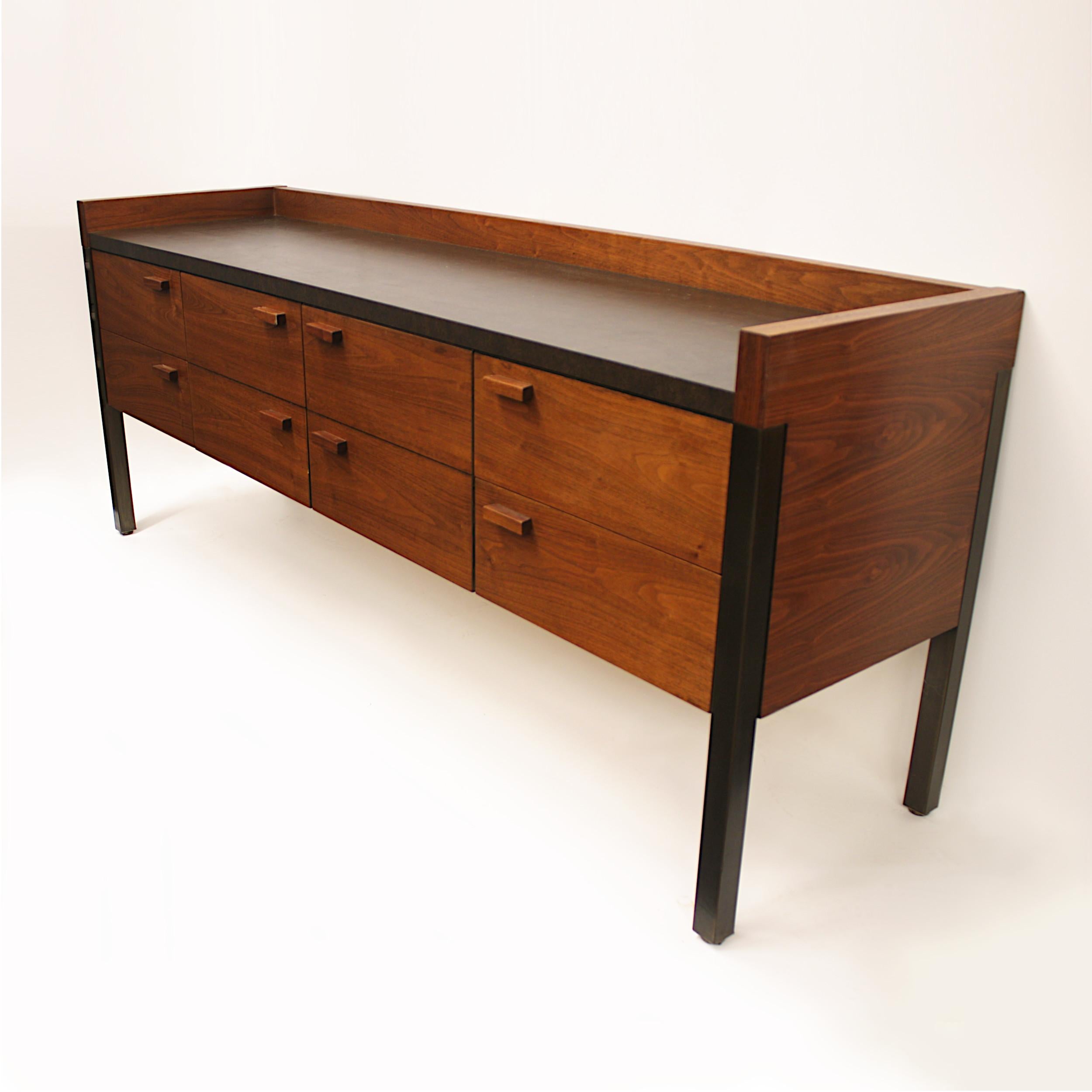 Fantastic Mid-Century Modern office credenza in the style of Knoll. This credenza was manufactured by the Monarch Furniture Co. and features a walnut cabinet, textured, brown Formica top, and 6 drawers (2 double file drawers in center). With its