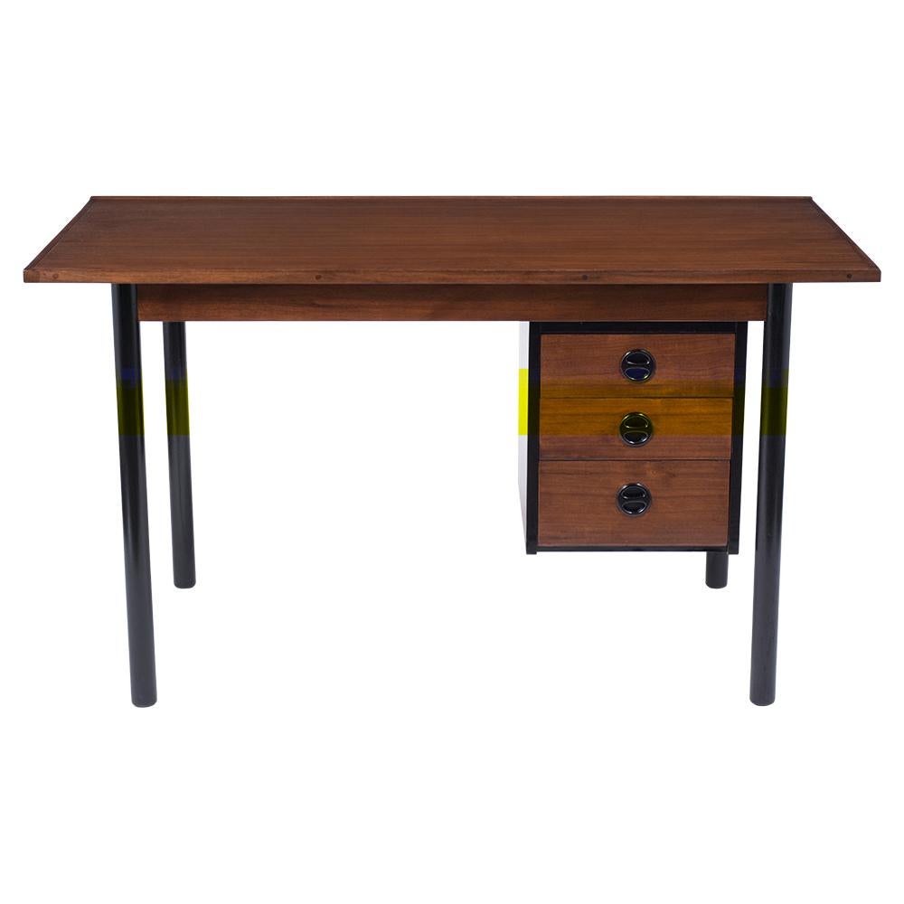 A Vintage Danish Modern Desk crafted out of walnut wood with a newly stained walnut and ebonized color combination with a newly lacquered finish. The writing table comes with a three-drawer cabinet with carved ebonized handles that can be positioned