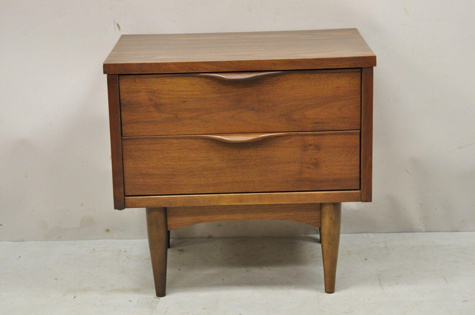 Vintage Mid-Century Modern walnut laminate top nightstand with sculpted pulls. Item features carved wood sculpted drawer pulls, beautiful wood grain, laminate top, 2 drawers, clean modernist lines. Circa mid-20th century. Measurements: 21