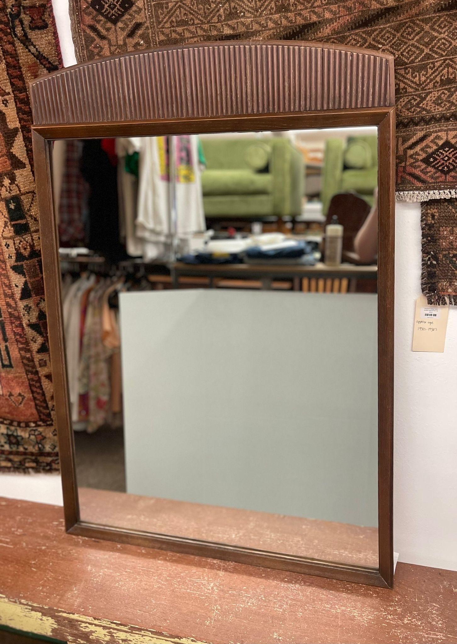 Wood Framed Mirror. The Top of this Mirror has Gorgeous Fluting. Vintage Condition Consistent with Age.

Dimensions. 29 W ; 3/4 D ; 43 1/2 H.