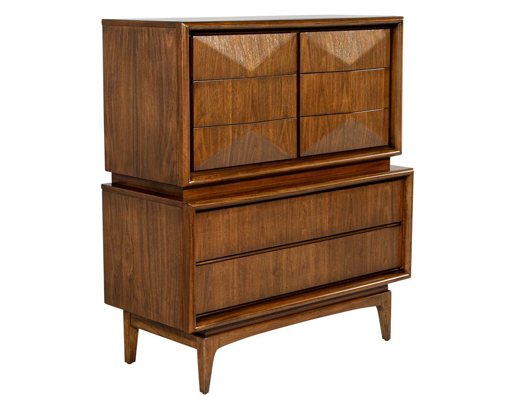 Step into the captivating world of mid-century modern design with this exquisite walnut wardrobe cabinet, meticulously crafted in the USA during the 1970s. Its timeless silhouette is adorned with six unique diamond-sculpted drawer fronts, each a