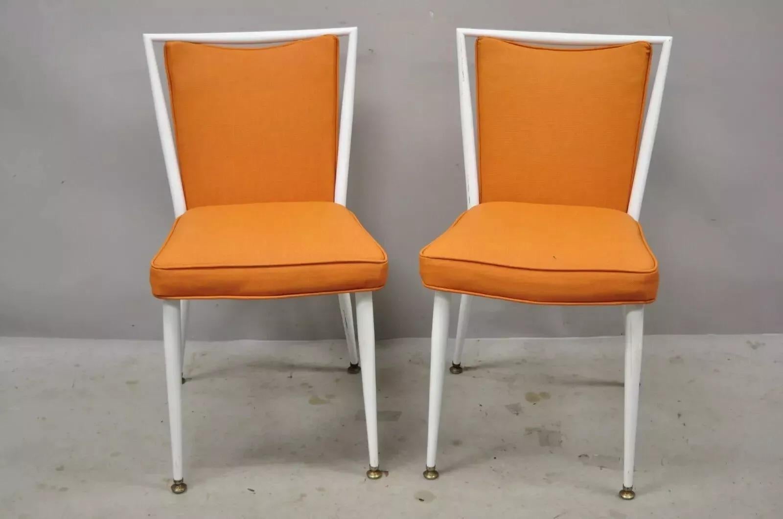 Vintage Mid Century Modern White Steel Metal Orange Dining Side Chairs - a Pair. Item features enameled steel metal frame, orange vinyl upholstery, very nice vintage item, quality American craftsmanship, sleek sculptural form. Circa Mid 20th