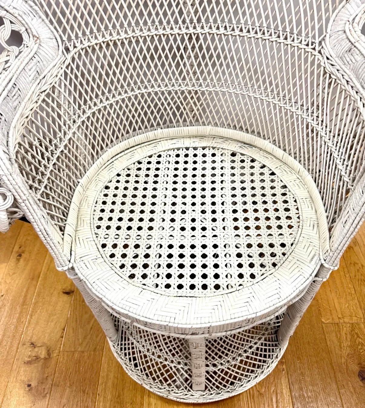 Vintage white wicker throne peacock chair that is a true statement piece - gracefully curved, beautifully woven, and ready to add a touch of drama to any room or patio.