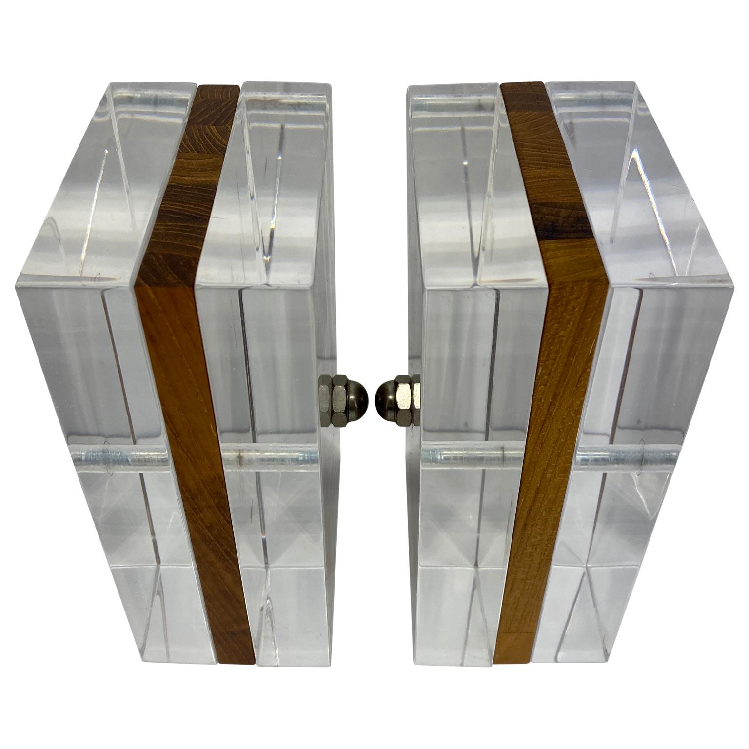 Just look at these unusual and striking pair of wood and lucite bookends. They are tall and handsome and can hold books or records. The detailing of wood being held together with a chrome rod make them especially unique. The polish of the lucite is
