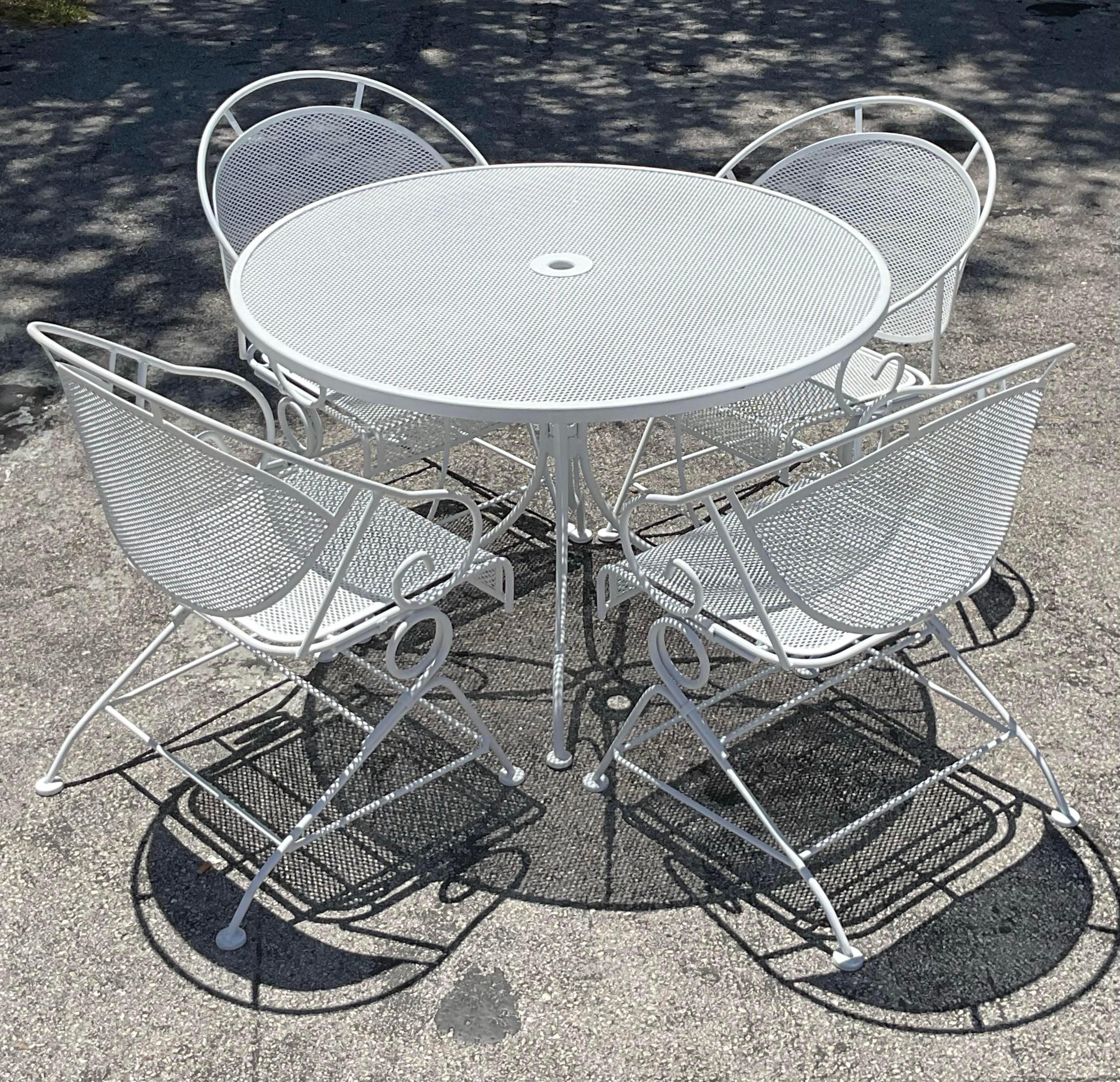 Elevate your dining experience with this Vintage MCM Wrought Iron Outdoor Dining Set of 5. Featuring sleek lines and mid-century modern style, this set adds a touch of retro elegance to any dining area.

Table - 42x42x28.25
SH- 15.25