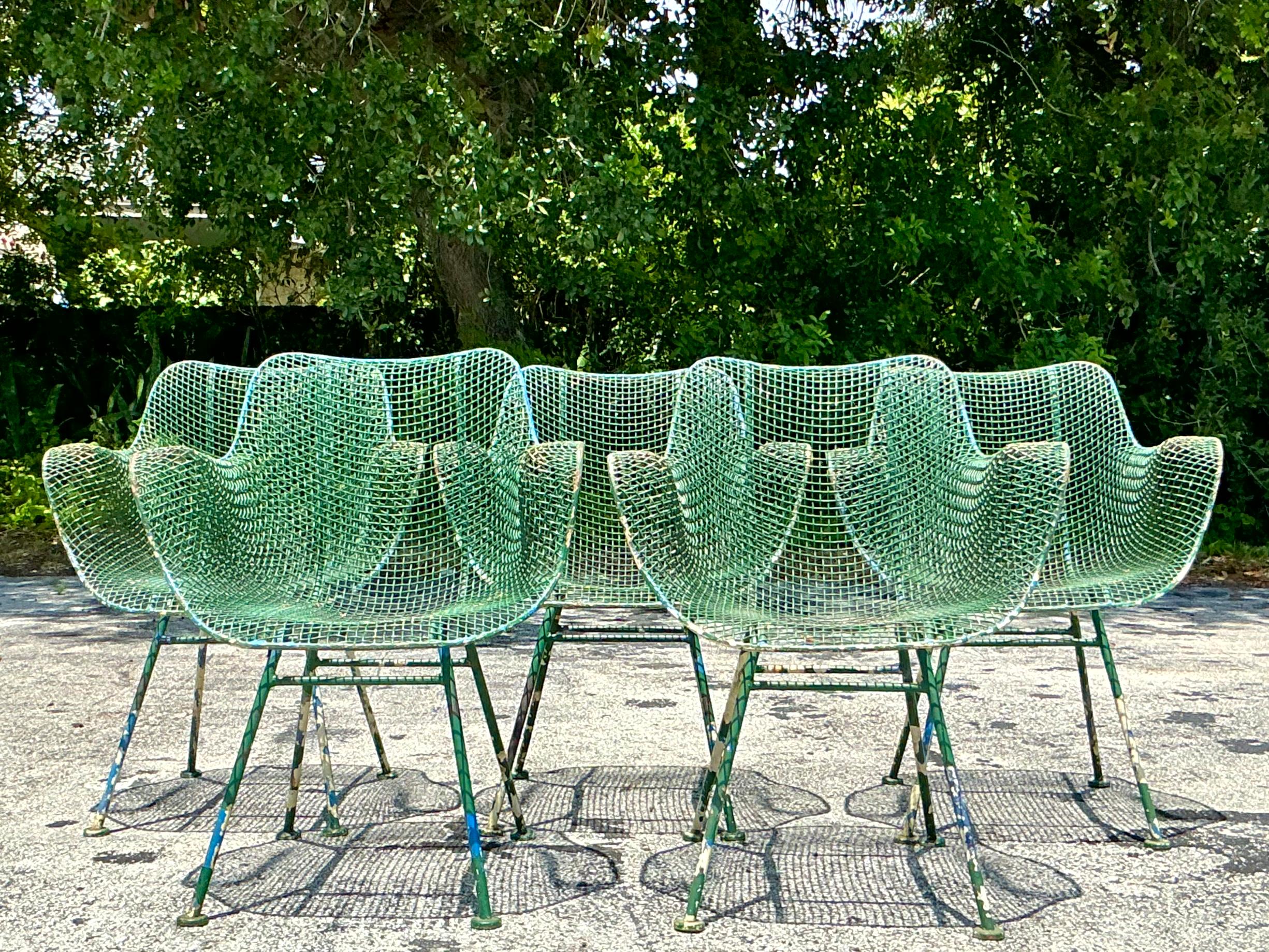 Elevate your seating with these Vintage MCM Wrought Iron “Sculptura” Chairs After Woodard. Featuring iconic mid-century modern design and sturdy wrought iron construction, these chairs offer a blend of artistic flair and enduring style. Perfect for