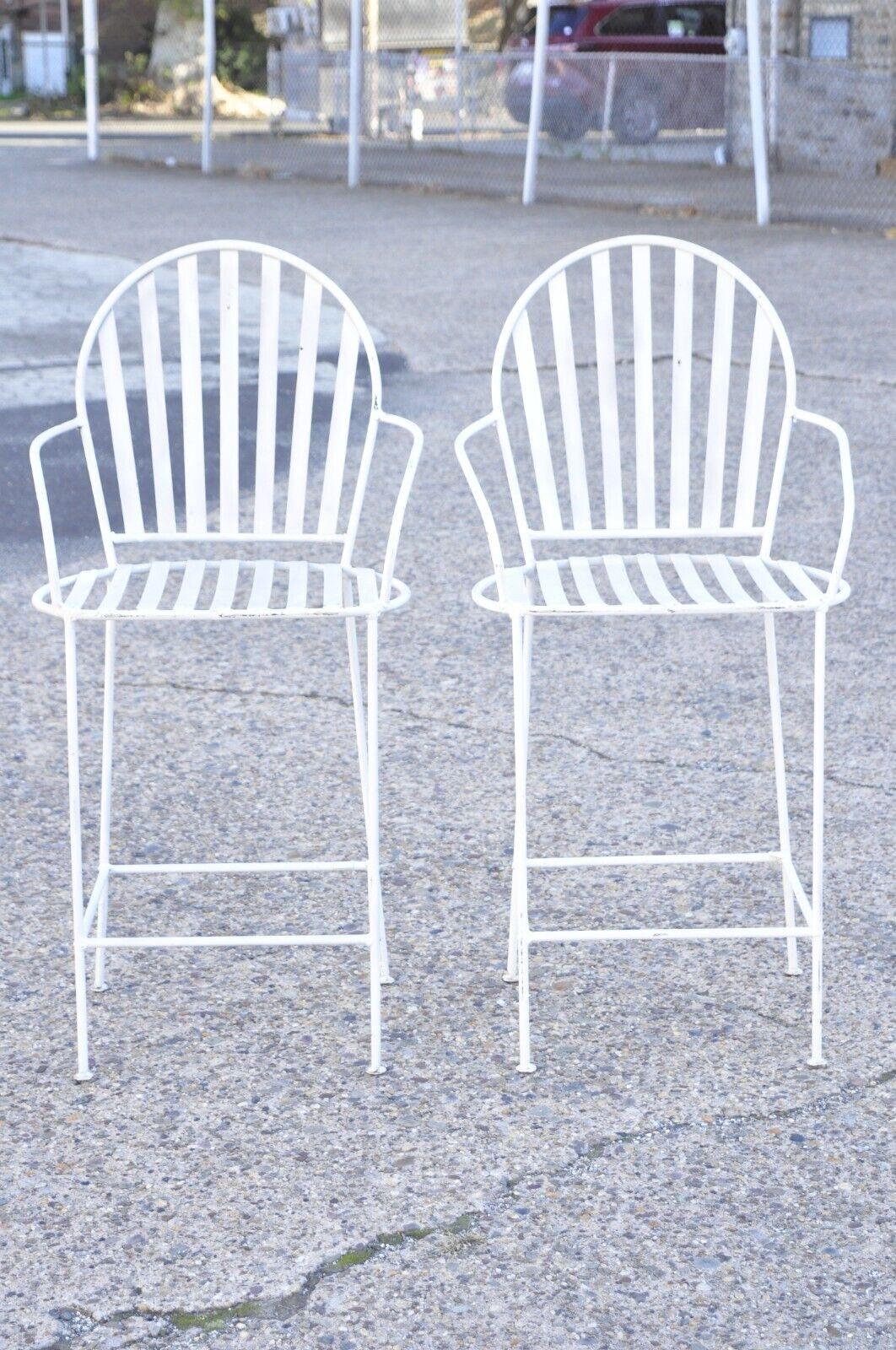 Vintage Mid Century Modern Wrought Iron Slatted White Painted Stools - a Pair. Item features slatted metal frames, wrought iron construction, clean modernist lines, great style and form. Circa Mid 20th Century. Measurements: 43.5