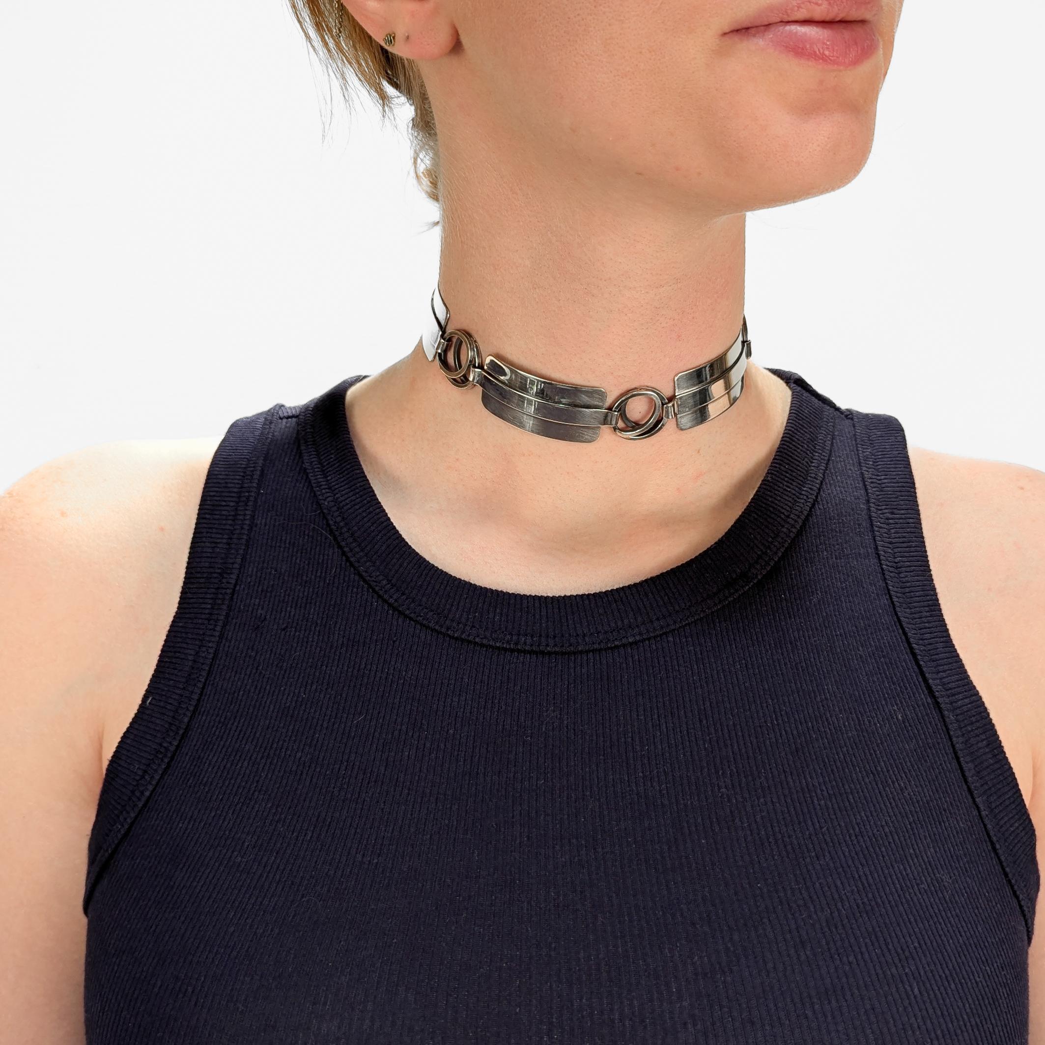 A fine signed Mid-Century Modern silver choker or collar necklace.

In sterling silver.

By Paul Lobel. Lobel was a Romanian-born and New York based jeweler, designer, illustrator who was an influential Modernist and beloved figure in the Greenwich