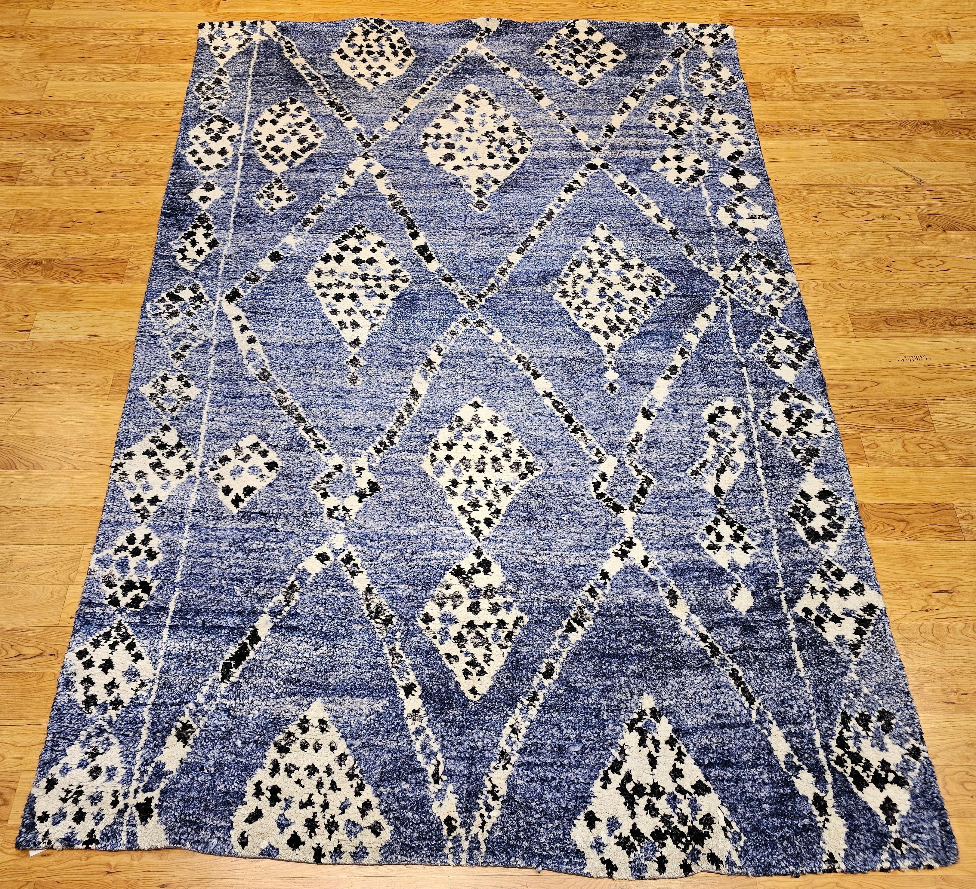Vintage Moroccan rug in an all over geometric pattern in pale indigo, navy and ivory colors.  The pale indigo is truly a wonderful shade of blue that has variation throughout the field that adds to the beauty of this room size or area rug.  The rug