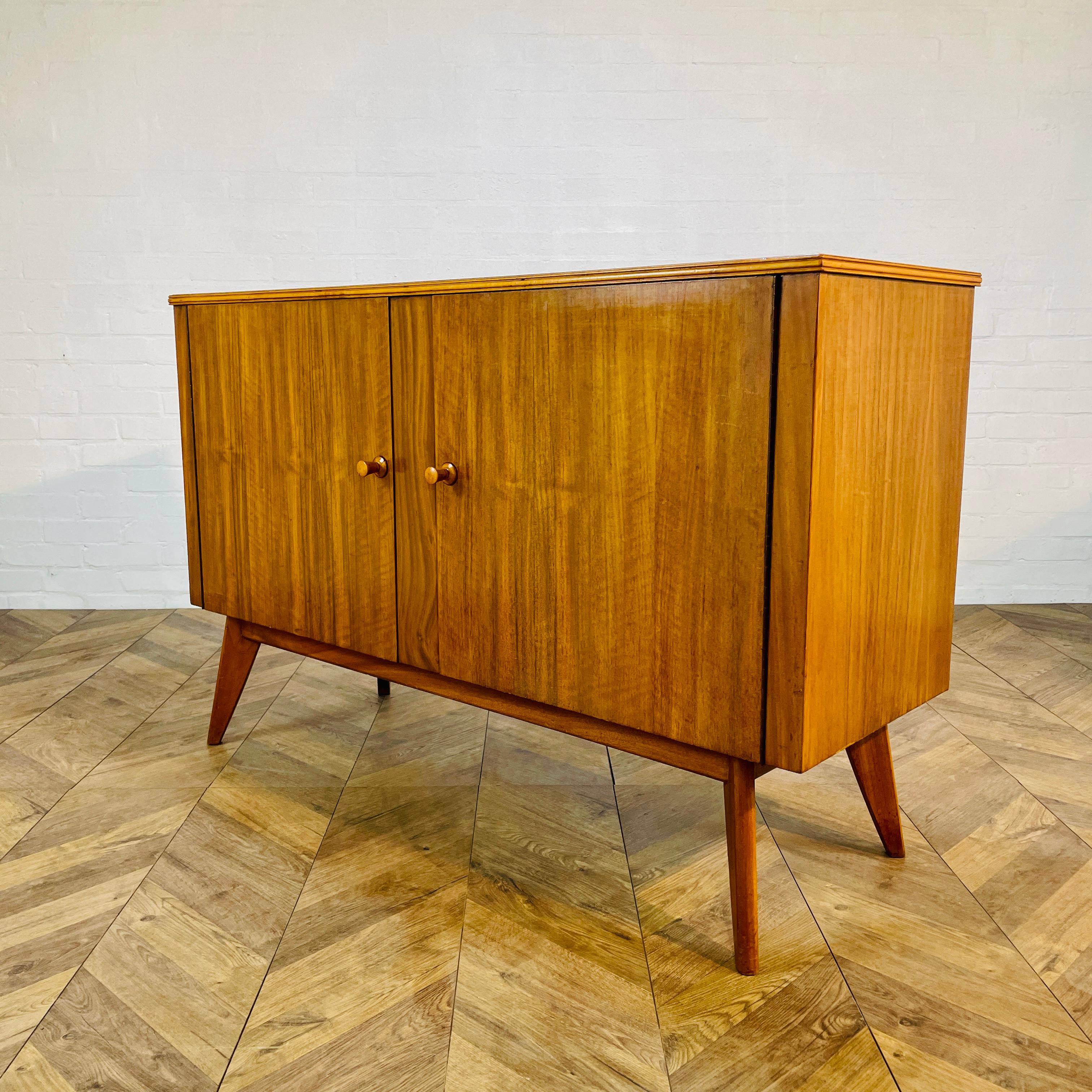 Simple, yet beautifully designed Sideboard by Neil Morris for Morris of Glasgow, circa 1960s.

The sideboard consists of two storage sections, to the left hand side there is a shelf and cutlery drawer. On the the right there is a fixed shelf.

The