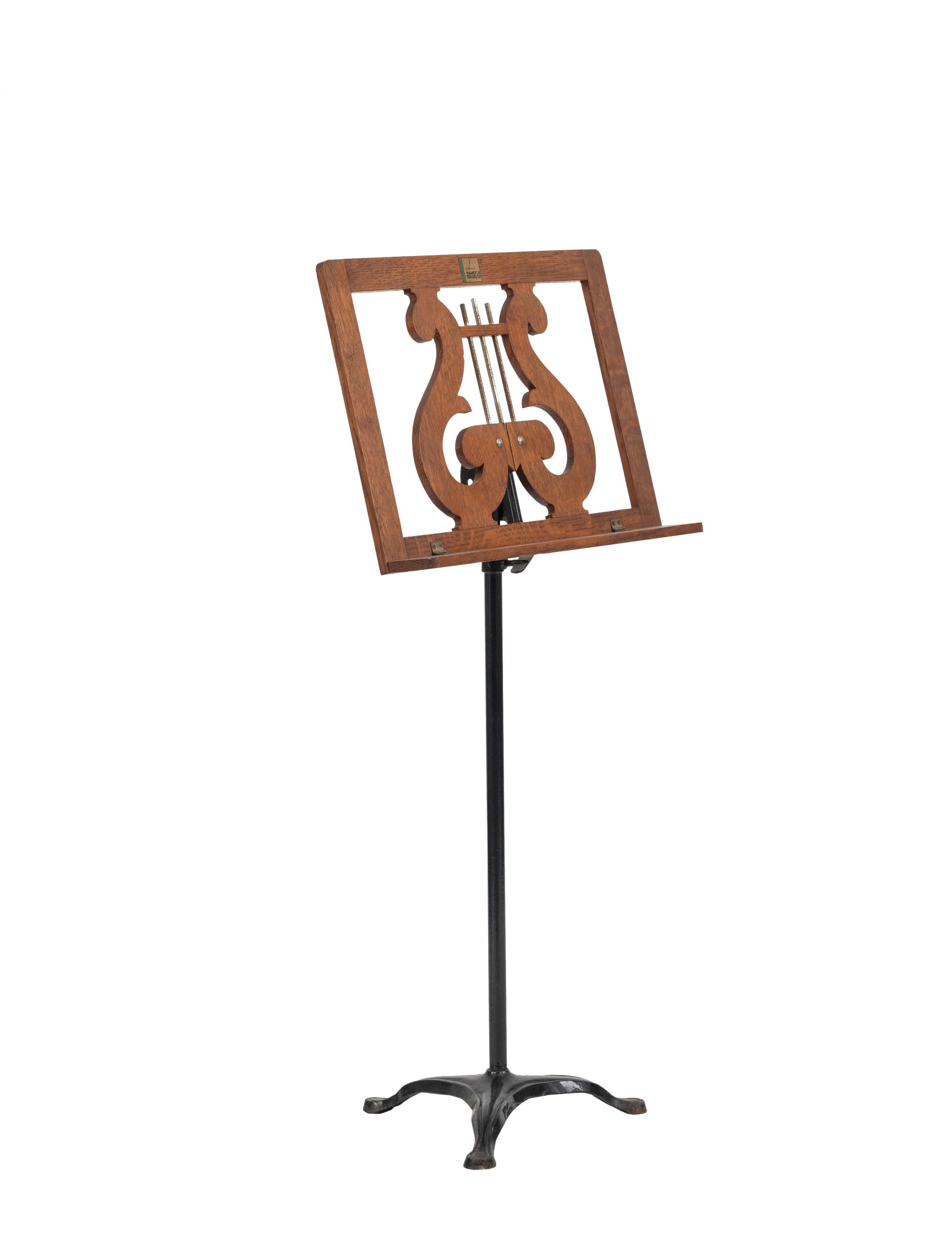 Vintage Mid-Century wooden music stand with scroll harp design and black metal pedestal base.