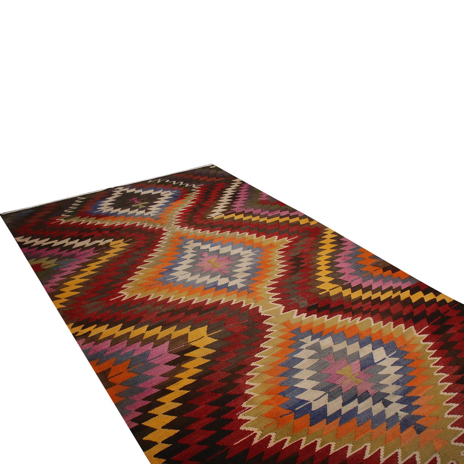 flat-woven in Turkey originating between 1950-1960, this vintage midcentury tribal Kilim hails from the town of Mut, celebrating a very idyllic but lively approach to tribal yellow, lavender purple, green, black, white, red, blue and orange colorway