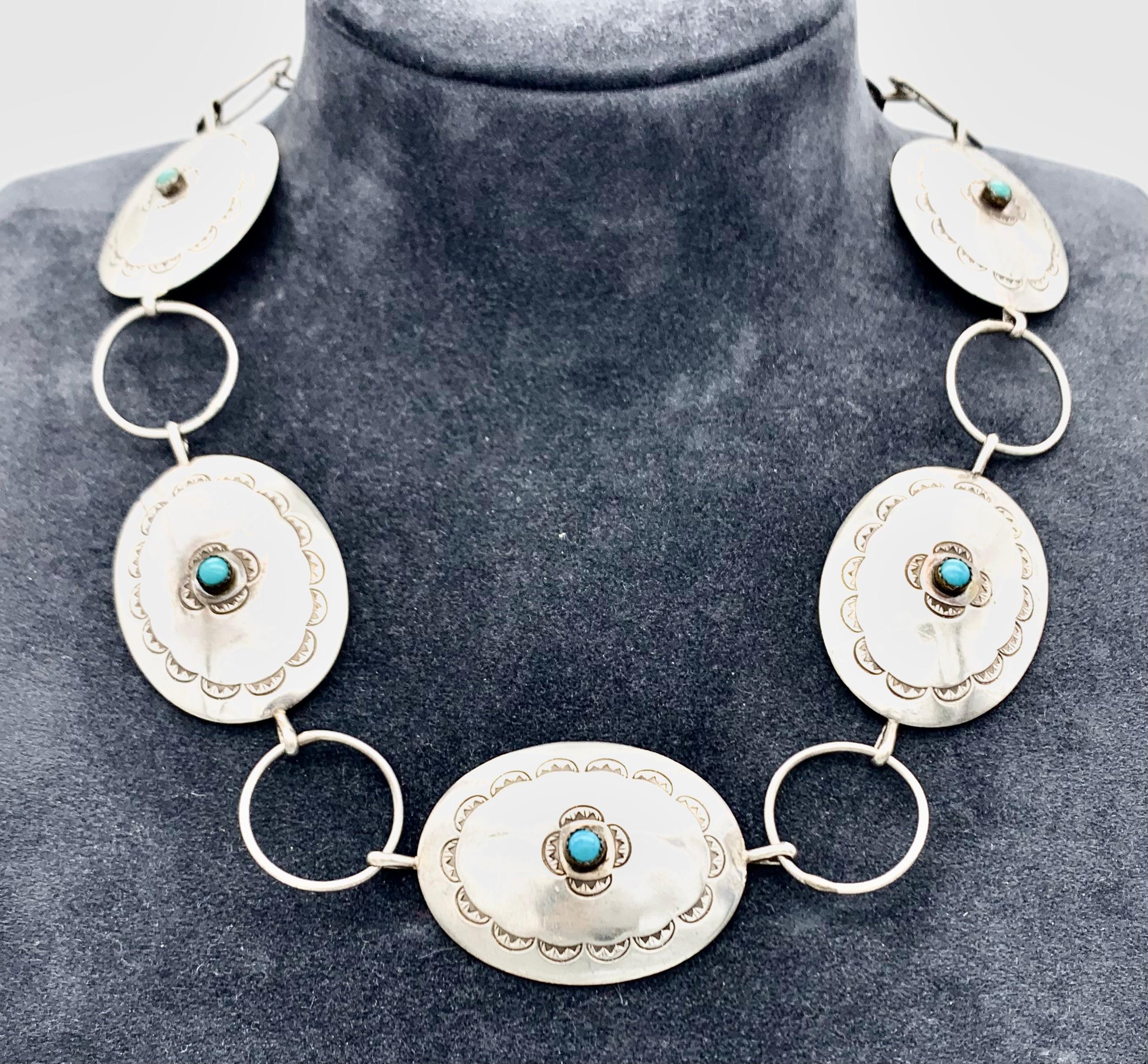 This Sterling silver necklace is decorated with turquoise cabochons and embellished with fine hand-engraving. 