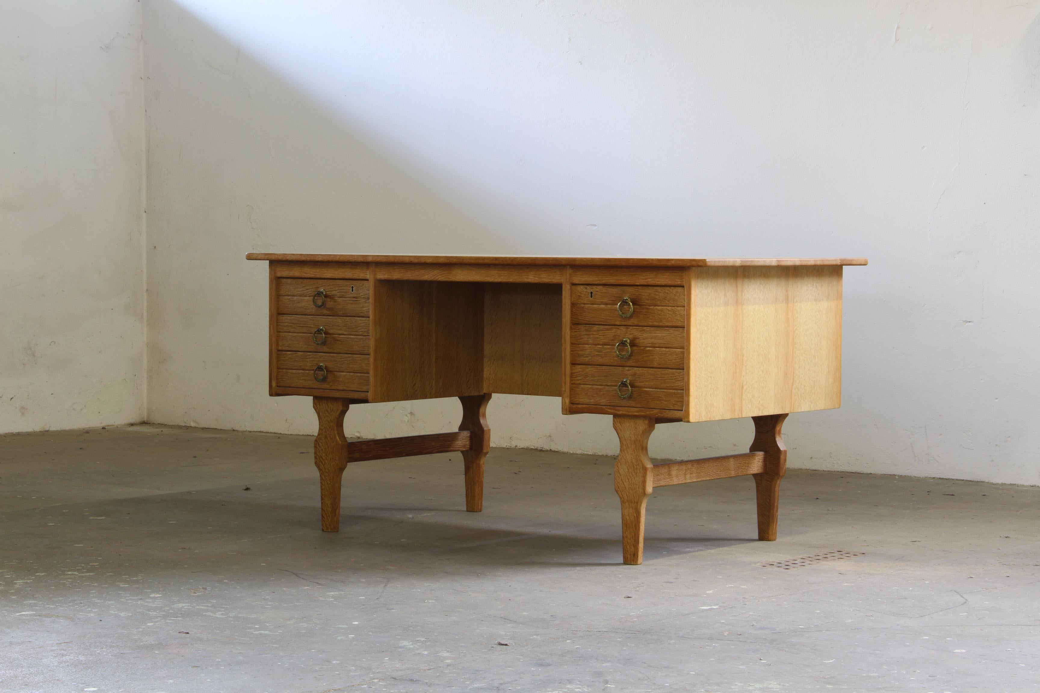 This finely crafted Brutalist Oak Desk from Denmark carries the quiet confidence of Danish mid-century design, echoing the sculptural spirit of Henning Kjærnulf. 

The iconic wooden legs with their characteristic carvings are slightly different than