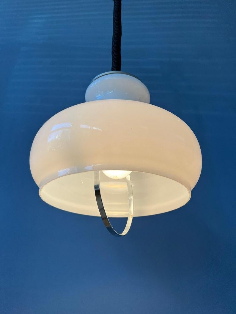 Classic white mid century opaline milk glass pendant lamp. The lamp is made out of thick glass and has a chrome top cap. The height of the lamp can easily be adjusted with the suspension cord. The lamp requires an E27/26 (standard)