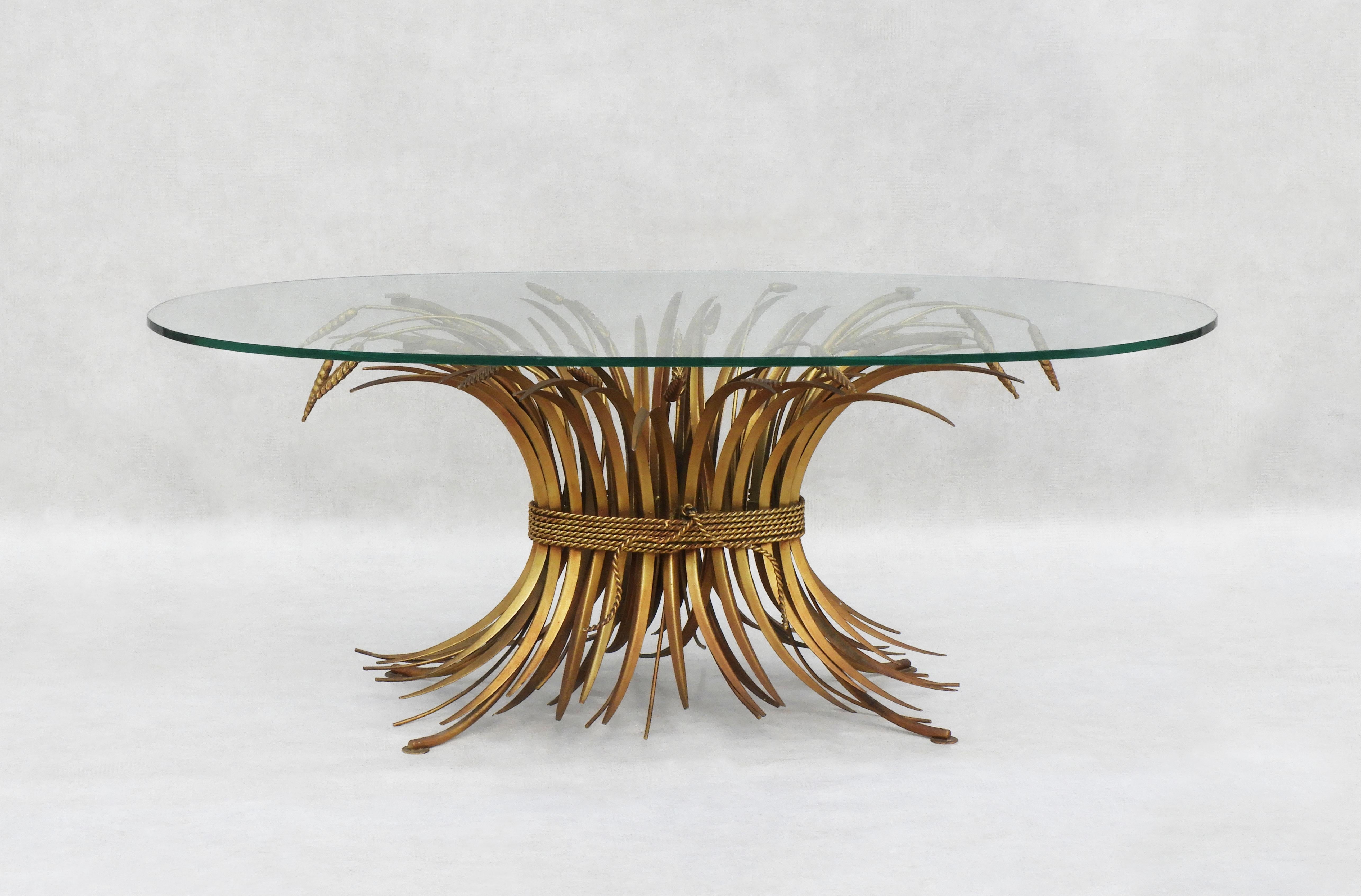 Gorgeous French golden 'Wheat Sheaf' coffee table from 1960s France. 
Stunning statement coffee table crafted in gilded steel with a clear oval 10mm plate glass top.
Attributed to the drawing by Robert Goossens for Coco Chanel.  
In very good