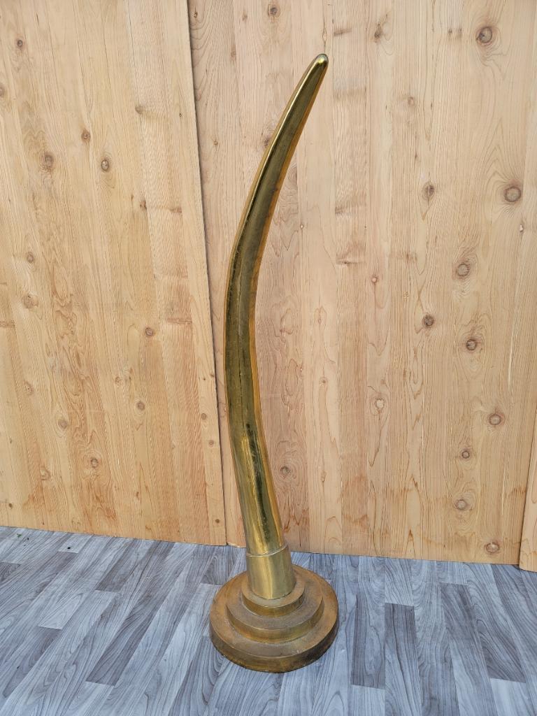 Vintage midcentury oversized brass elephant tusk horn 

Bold midcentury sculpted decorative brass elephant tusk/Horn. This impressive and rare sculptural piece boasts of a strong presence that will enhance any interior. A perfect, strong and