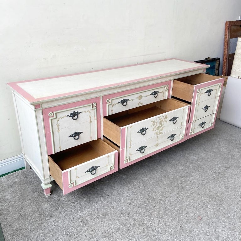 Exceptional traditional mid century dresser by John Widdicomb. Features 9 spacious drawers with a painted white, green and pink finish.

Additional information:
Material: Wood
Color: Off-White, Pink
Style: Mid-Century Modern
Time Period: