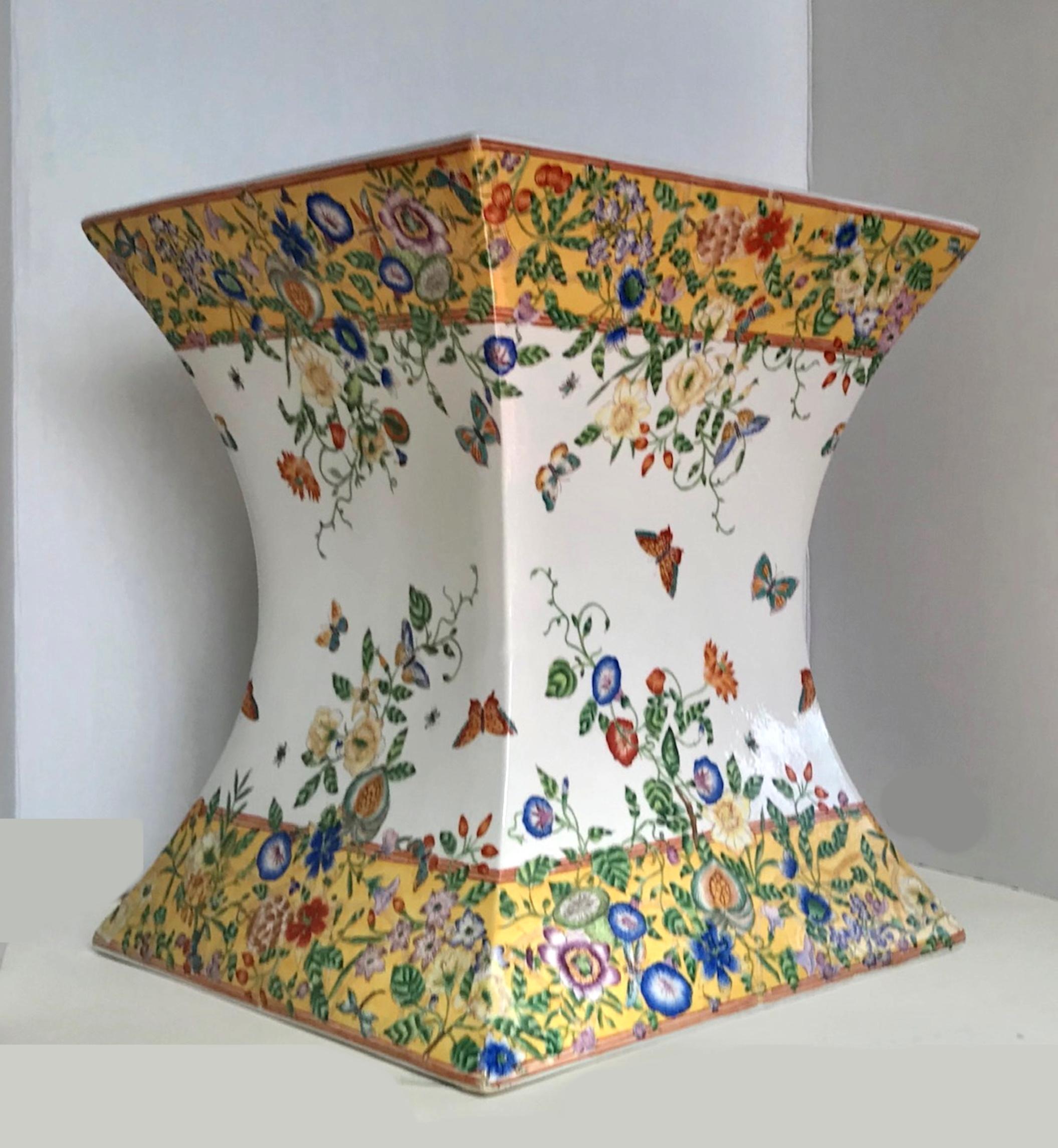 Vintage midcentury polychrome enameled Chinese porcelain garden seat.

Gorgeous exotic Chinese garden stool in an unusual and rare trapezoidal hourglass shape. It is beautifully hand painted with vibrant colors and lovely details. Multicolored